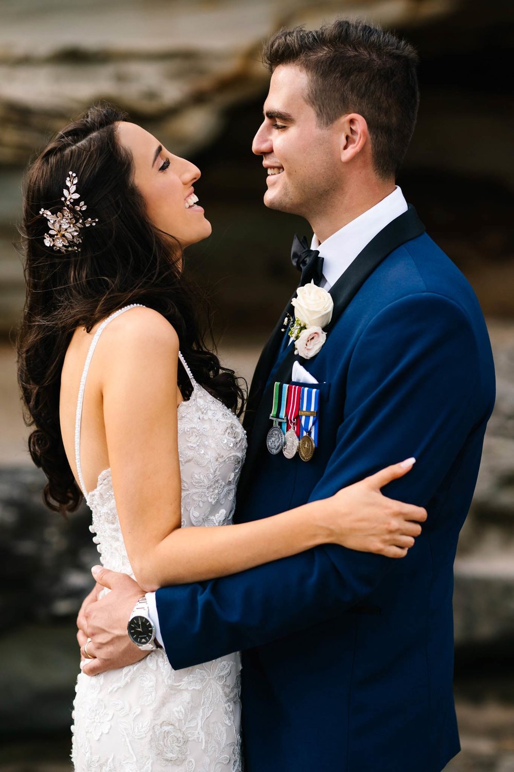 Bride and groom embracing and looking happy