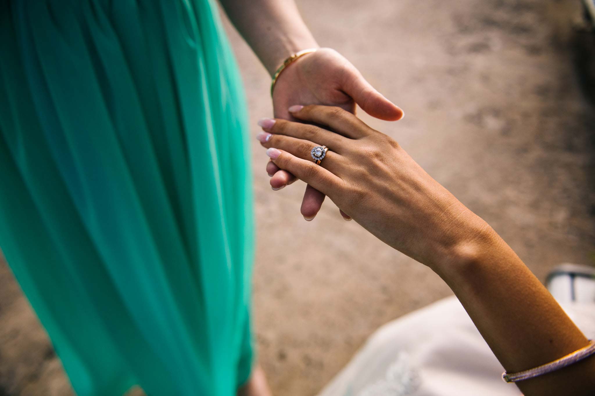 Bridesmaid inspects bride's new rings