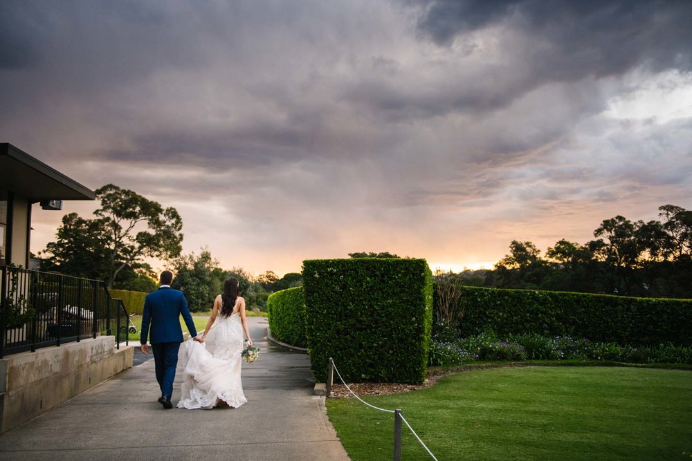 Beautiful sunset clouds above couple at Manly Golf Club