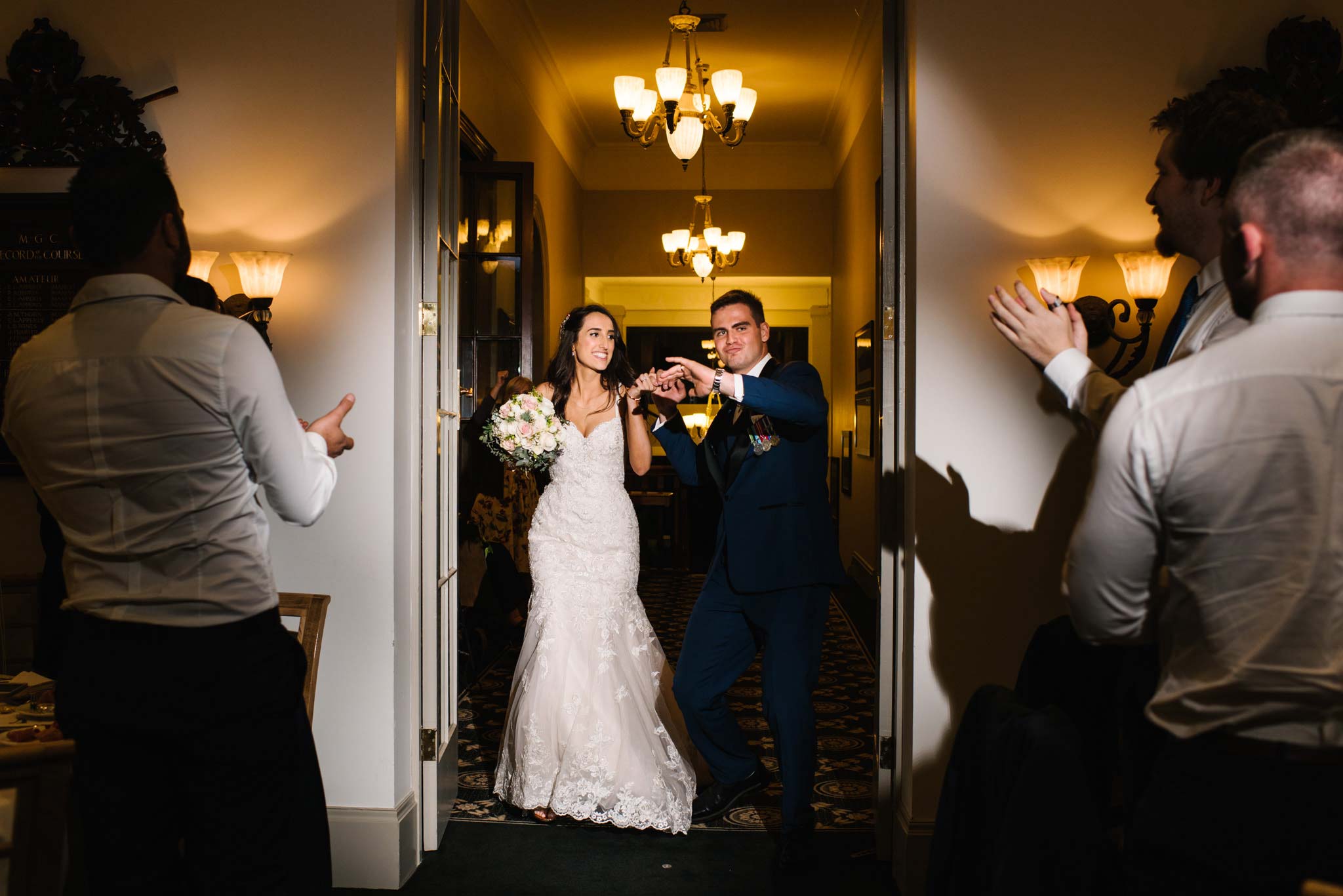 Bride and groom make their big entrance at Manly Golf club reception