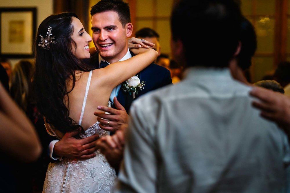 Newlyweds laugh during dance at wedding reception