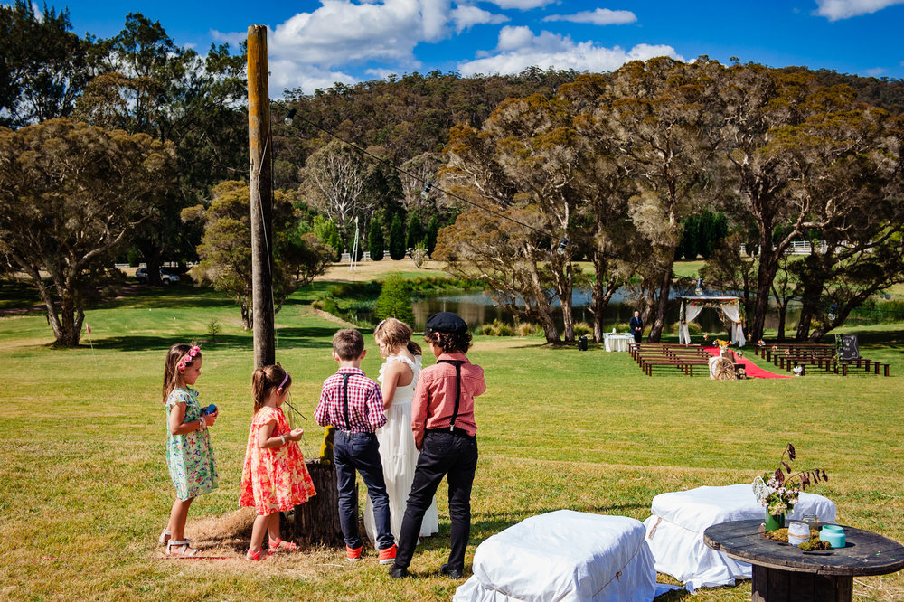 Kids waiting for wedding ceremony to begin at Redwood park Wollombi