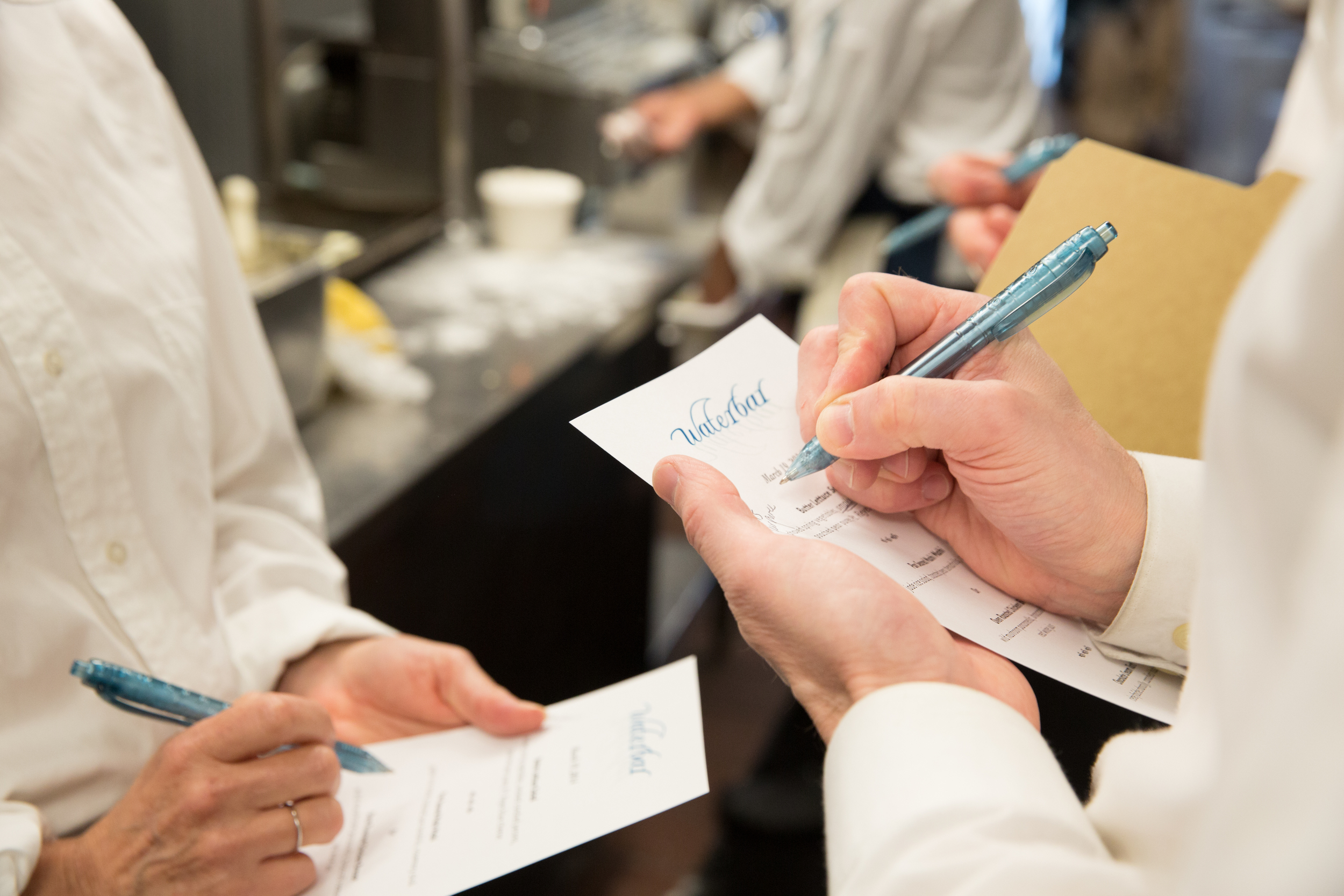 A photo of an employee writing orders. #waterbar #waterbarsf