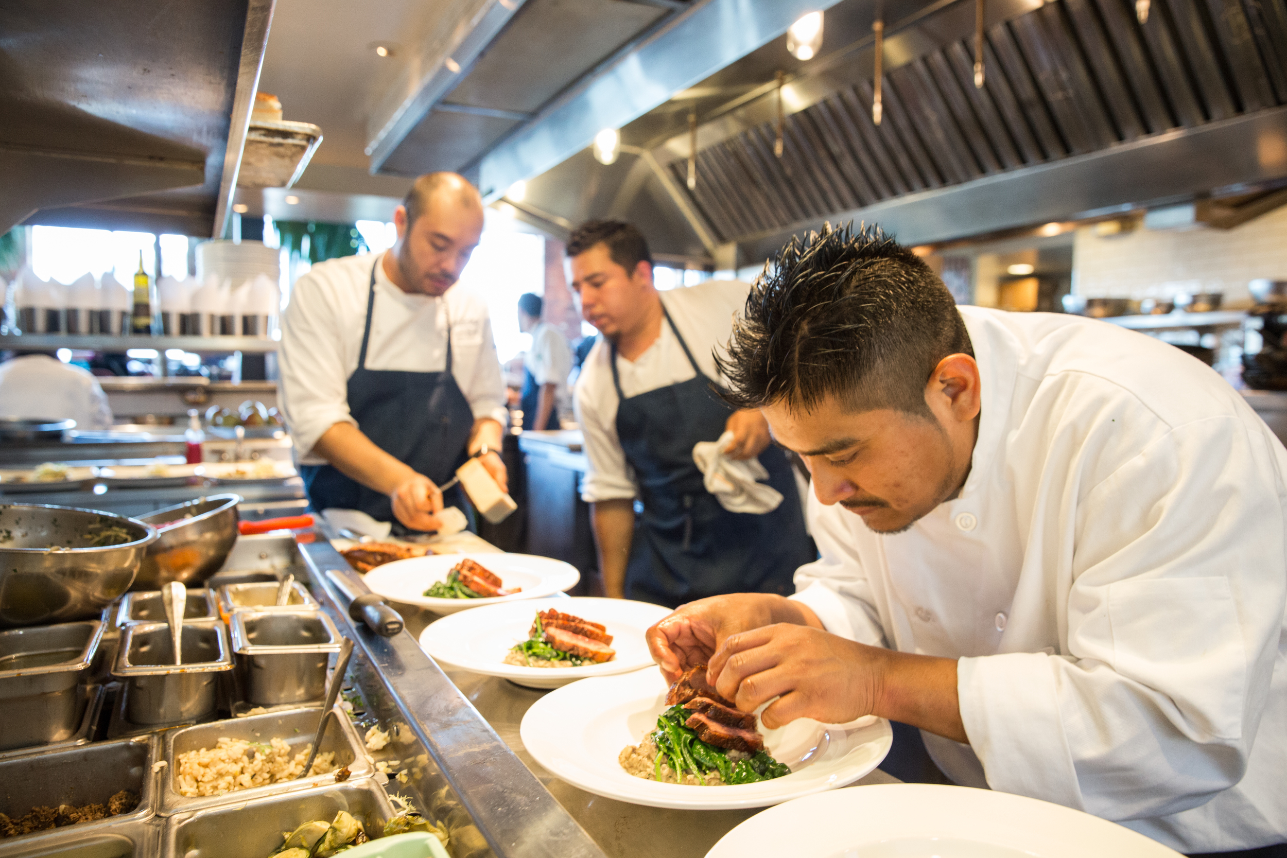 A photo of employees plating food. #waterbar #waterbarsf