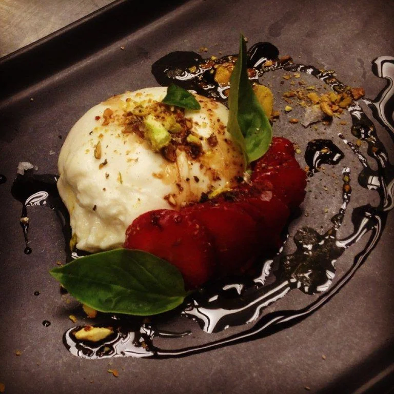The final product, Waterbar's Housemade Burrata Q: Where are you from? A: Los Osos, along the Central Coast of California. Q: How did you get into restaurants? What was the attraction? A: It started with summer jobs. Although I started in the front of the house, it was the level of respect I had for the Chefs I'd worked for that ultimately made my decision. When I decided the restaurant business was the career path I would follow, I knew it would be as a Chef. Q: How long have you been at Waterbar? A: A little over two years. Q: What’s been your greatest challenge as a chef? A: Balance. With life and work. With staff and management, confidence and humility. You start to realize that once you live your life as you do at work, the lines blur. Passion can be an intense motivator, leaving you feeling powerful and powerless from one moment to the next. Q: What’s your best memory in the kitchen? A: There are so many, but one of my favorites that always stands out was during an opening. My girlfriend at the time (fiance now), who also works in the service industry, was at the bar and saw a few servers walk by food in the window while I struggled to get my staff out of the weeds. I heard her yelling at them from the bar to run the food while it was still hot. It was amazing, and if I wasn't already madly in love, that pretty much sealed the deal. She was a keeper. Q: What are you up to lately, what’s on your agenda? A: I'm constantly looking at ways to keep up with trends in the industry- not to be doing what everyone else is doing, but attempting to get ahead and do something first. Possibly that could inspire others to make moves in a positive direction. I have fun with food creation, as does anyone, but it's the impact restaurants and food production have on the environment that drives me. Knowing what's in season used to be a trend, now it's necessity. Organics is no longer just some kitchy stuck up term. Sustainability is responsibility. Making sure we have an understanding what these terms mean and passing that understanding on; building a better future with what could just as easily be left as a negative footprint. While we work on having fun creating food made from some of the most awesome ingredients in the world, we're consciously trying to do it in a way that highlights them with the utmost respect. Q: What are your plans for the future? A: More fun projects of course! Mostly trying to get involved in as many of our fun Waterbar projects as possible. We go on so many cool field trips, do parties like High on the Hog, and of course Oysterfest. This year I'm trying to get my hands in on the beekeeping, and help out with the rebuilding of our rooftop garden.