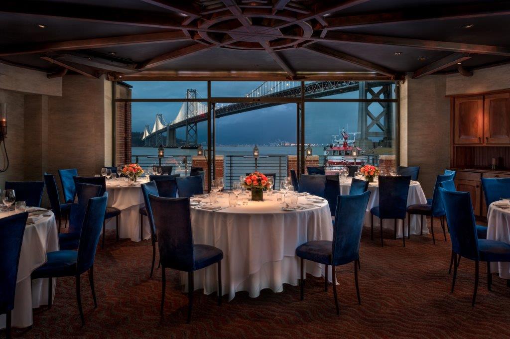 Photo of private dining room with view of Bay Bridge at night