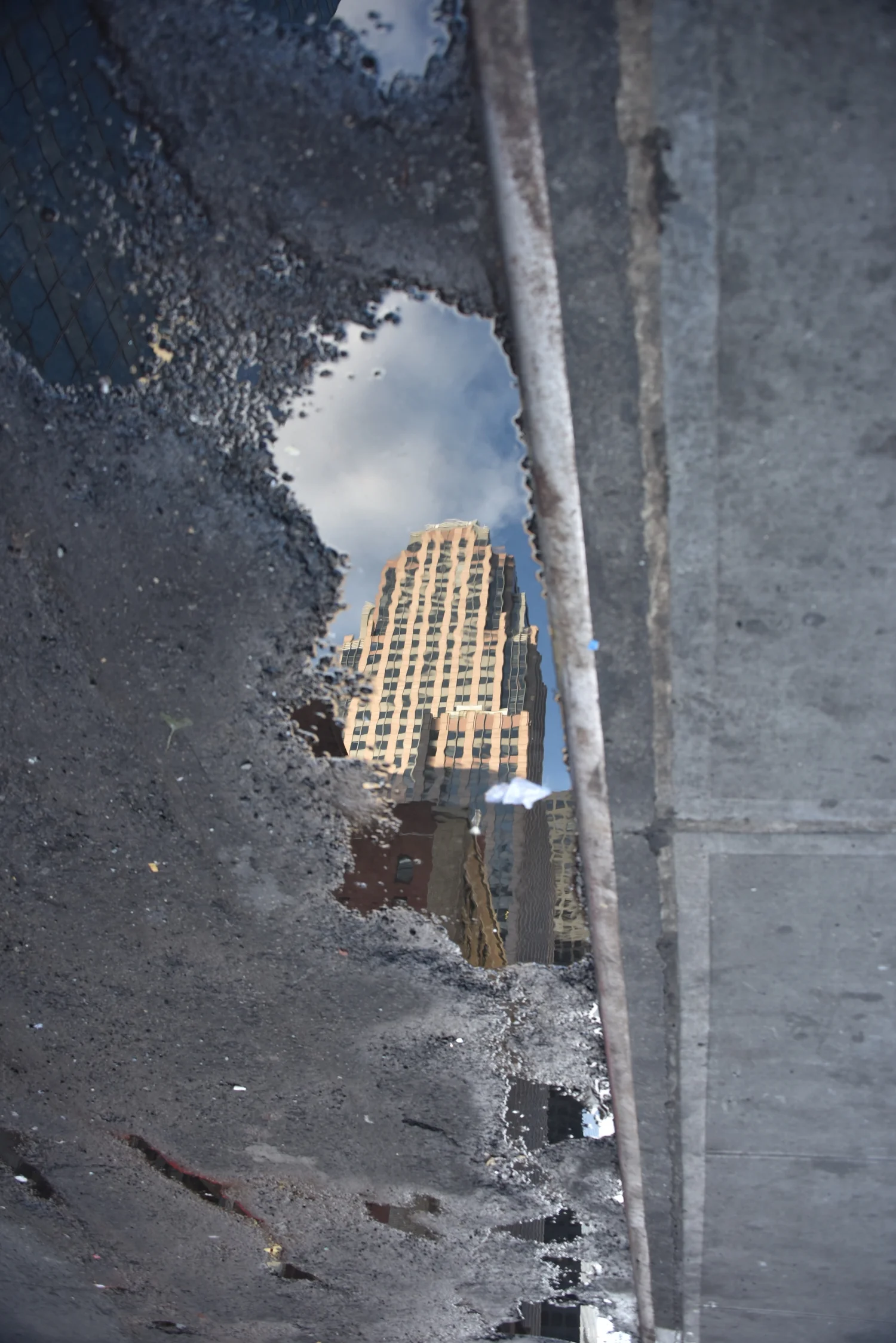 Reflection of Building in a Puddle in the Street