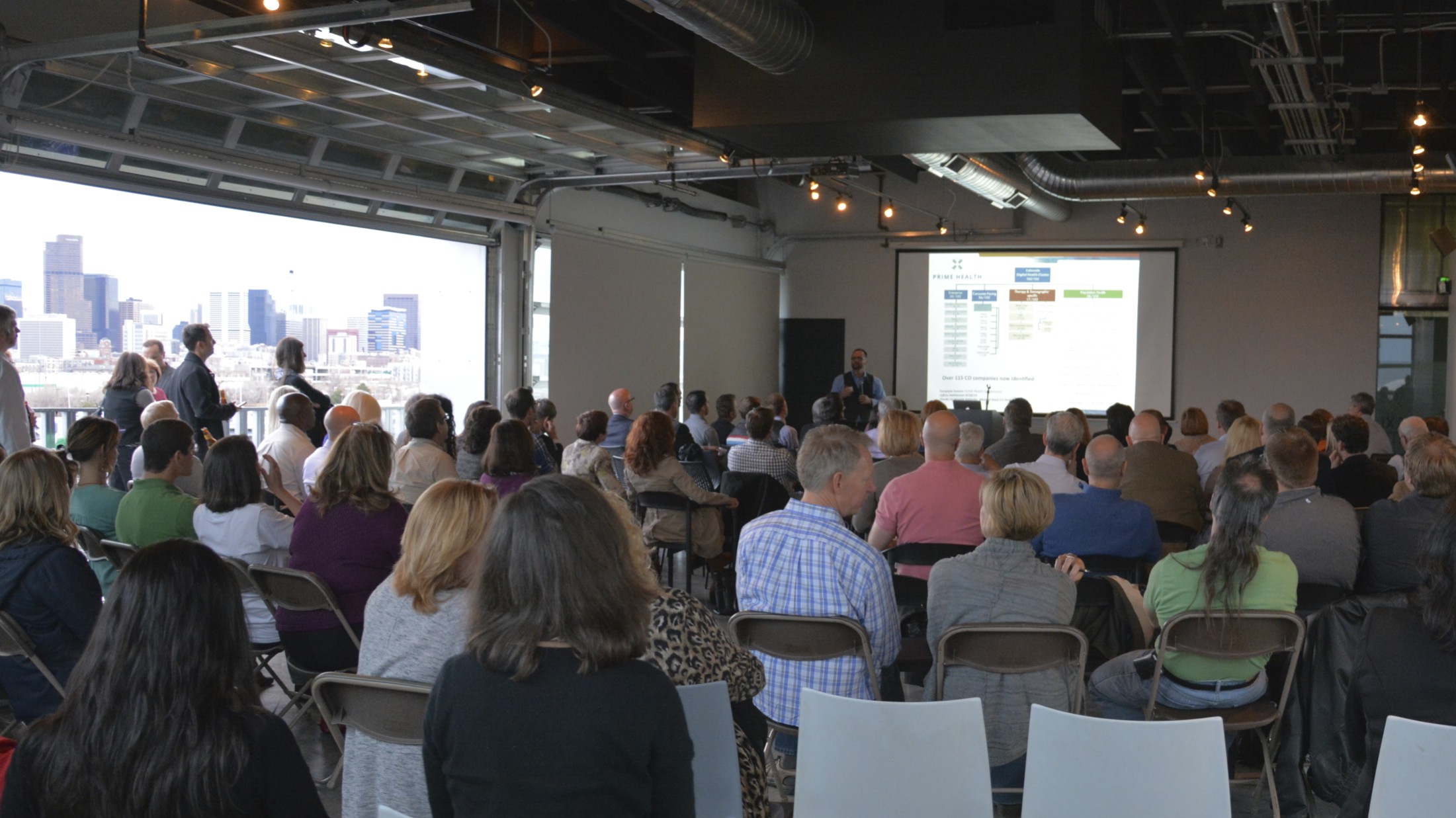 With the Denver skyline in the background, Mike Biselli pushes the digital health vision forward at the March 2015 Prime Health Meetup at Taxi.