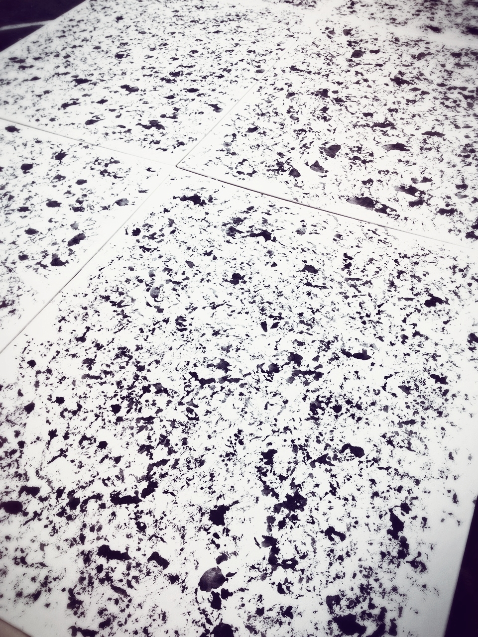 Black acrylic paint is sponged on to create a random speckle pattern.