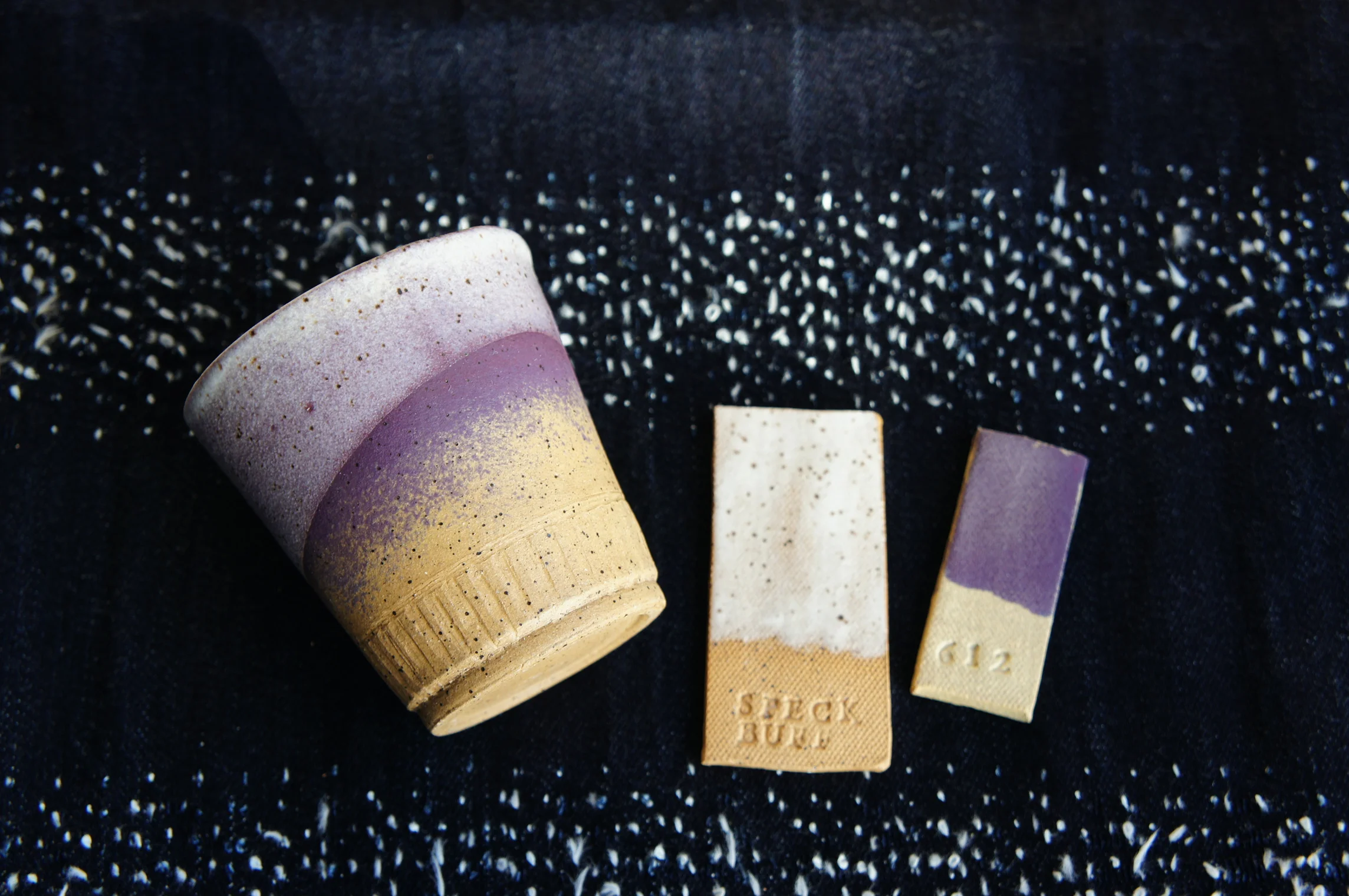 Coat 1: Western UG-22 Plum underglaze applied by sponge in layers to create a light gradient effect. Coat 2: Laguna MS-250 Matte White Pebble glaz applied by a quick dip at an angle.