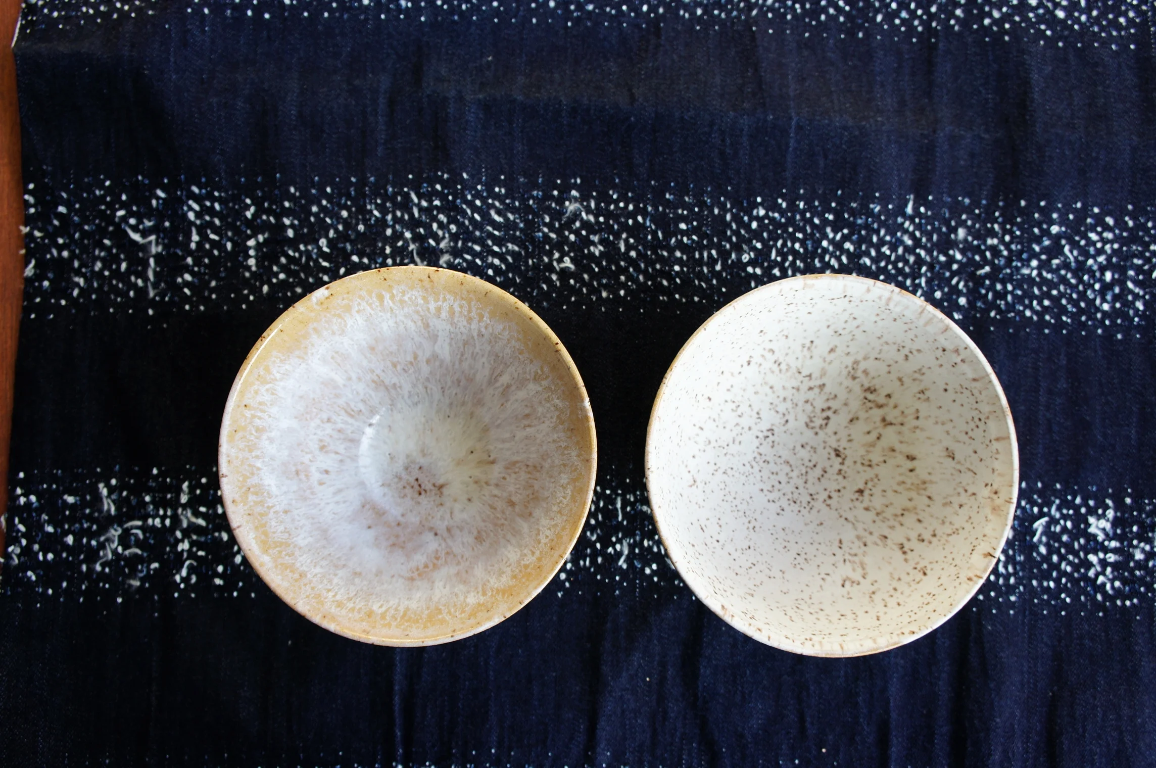 Left bowl Coat 1: Laguna? Clear Gloss applied by pouring in the glaze Coat 2: Laguna MS-250 Matte White Pebble glaz applied by pouring in the glaze Seems the clear glaze makes the matte white very runny and it created this pattern. Right bowl Coat 1: Laguna MS-250 Matte White Pebble glaz applied by pouring in the glaze The random brown speckles from the clay show clearly.