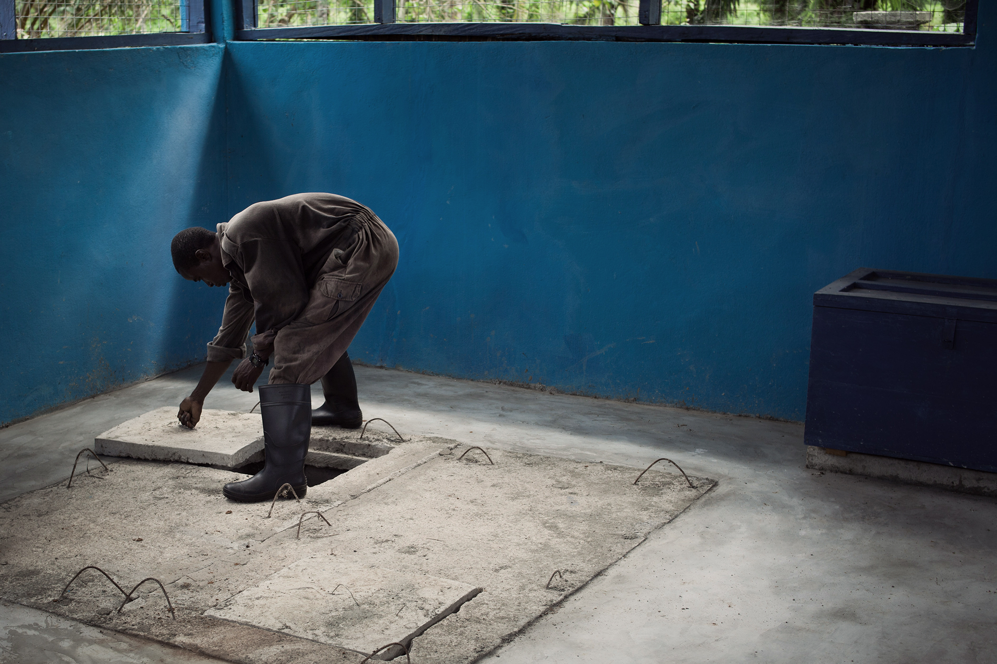 Man opening furnace hatchet, Sierra Leone. 