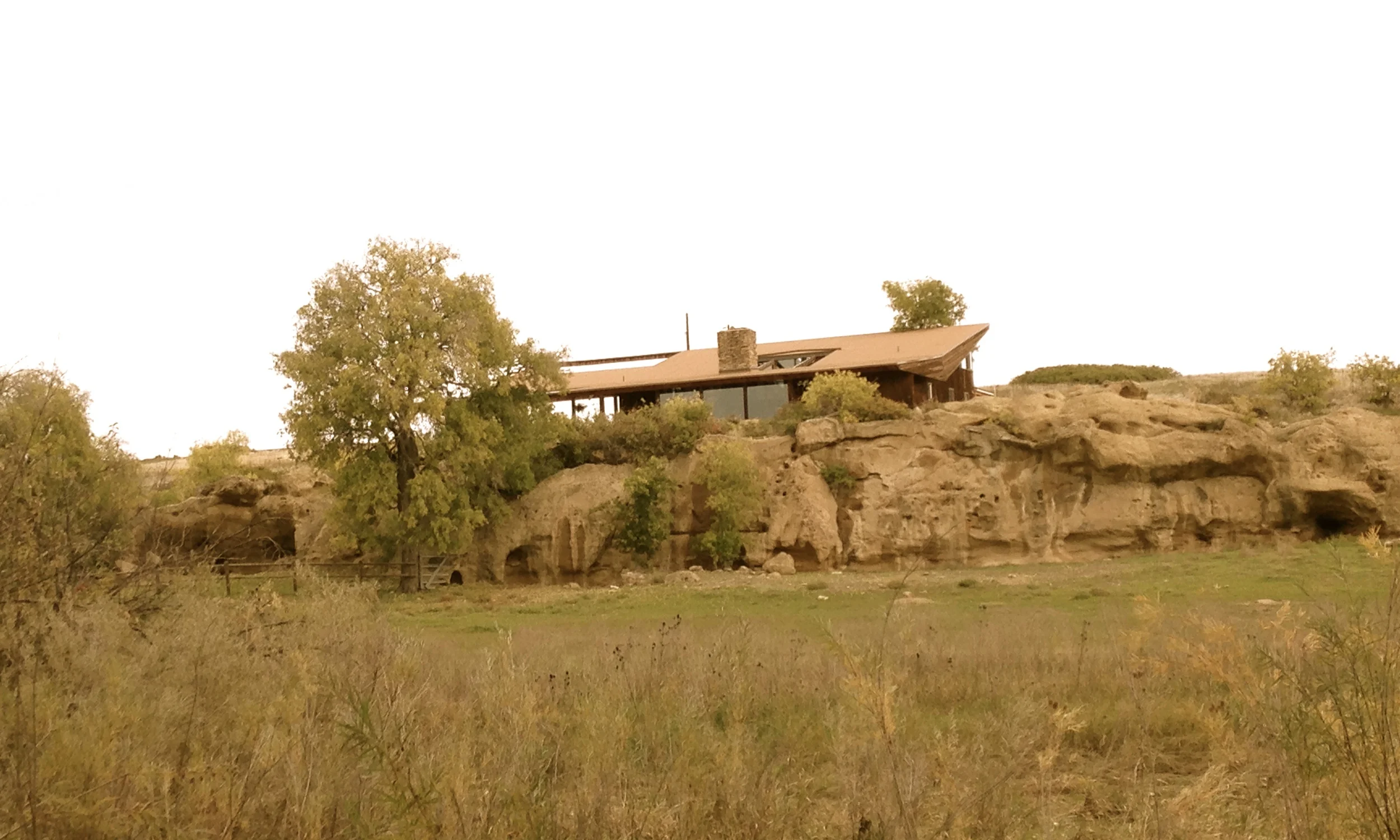 The home rests above a natural rock outcropping.