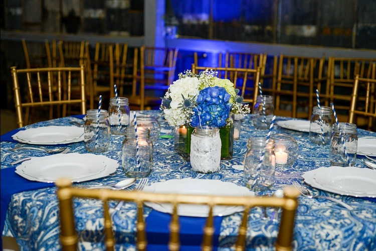 Tryston Hines Photography , from Cara + Brock 's wedding at The Barn. These blue paisley tablecloths were the inspiration behind the whole look of this wedding!