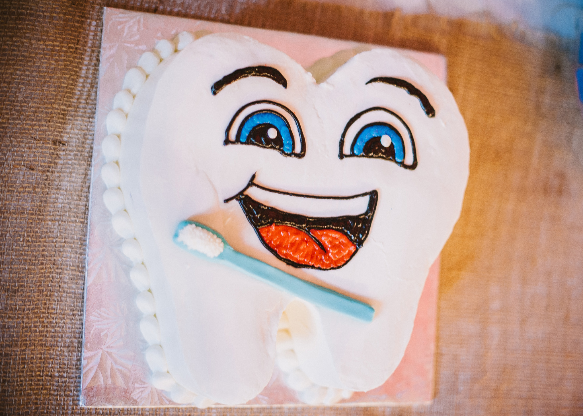 BnBauman Photography , from Chelsea + Logan 's wedding. Logan was in dental school at the time of his wedding, so this precious tooth groom's cake was a must! He and his bride also gave toothbrushes and floss as favors. 