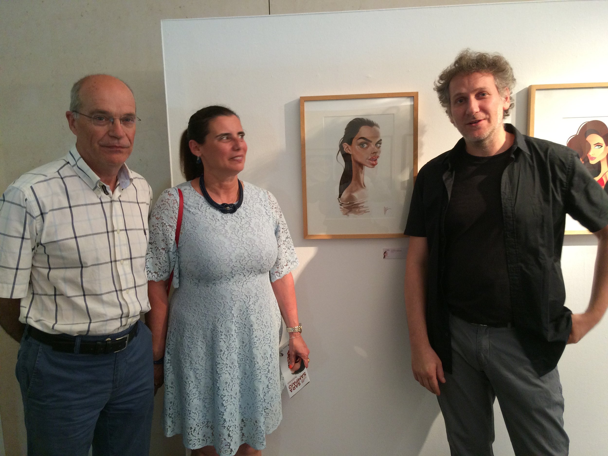 Sara Sampaio's parents and Marzio Mariani (author of the caricature) in front of the artwork that won the First Prize for the caricature contest at the PortoCartoon Festival 2016.