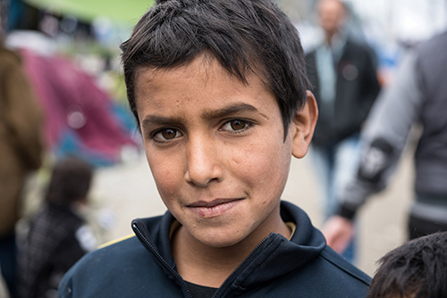 © Dinosmichail | Dreamstime.com - Boy In Refugee Camp In Greece Photo