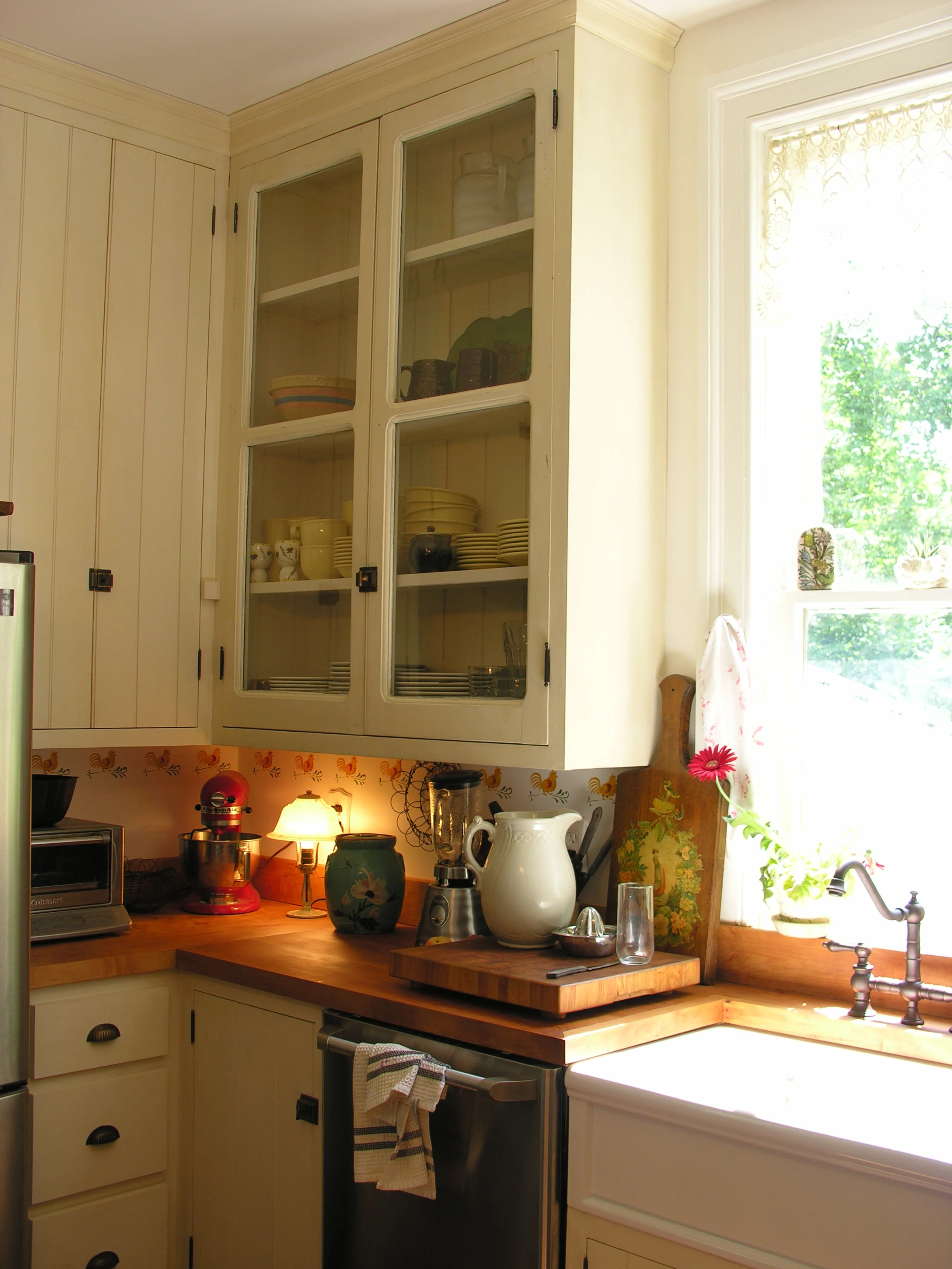  This kitchen was designed around two salvaged glass cabinet doors. The countertop is 2 inches of solid maple finished with strong coffee and mineral oil. 