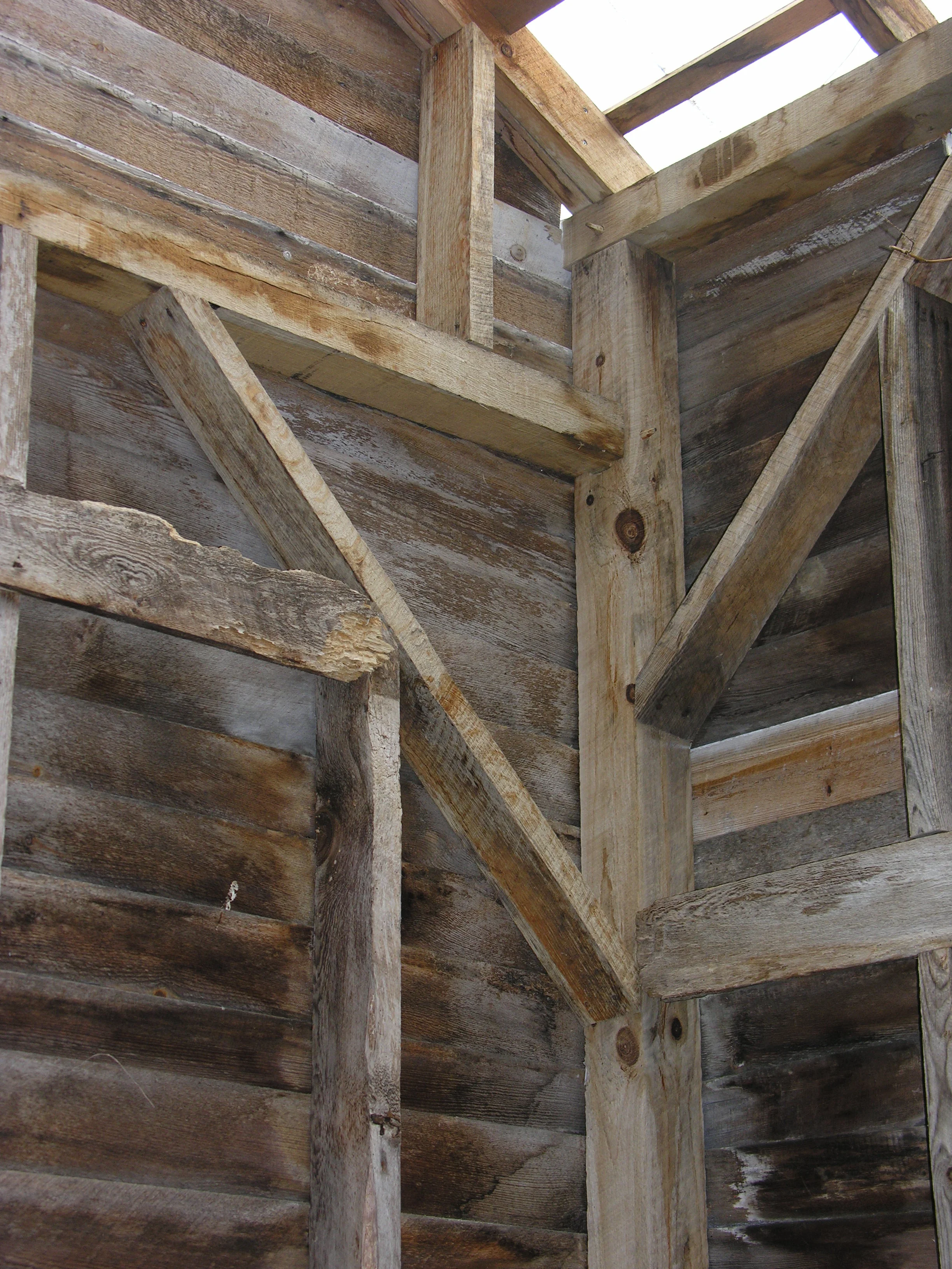  Oak beams on this braced-framed outbuilding were reconstructed in the original manner using pegged mortise and tennon joints.    