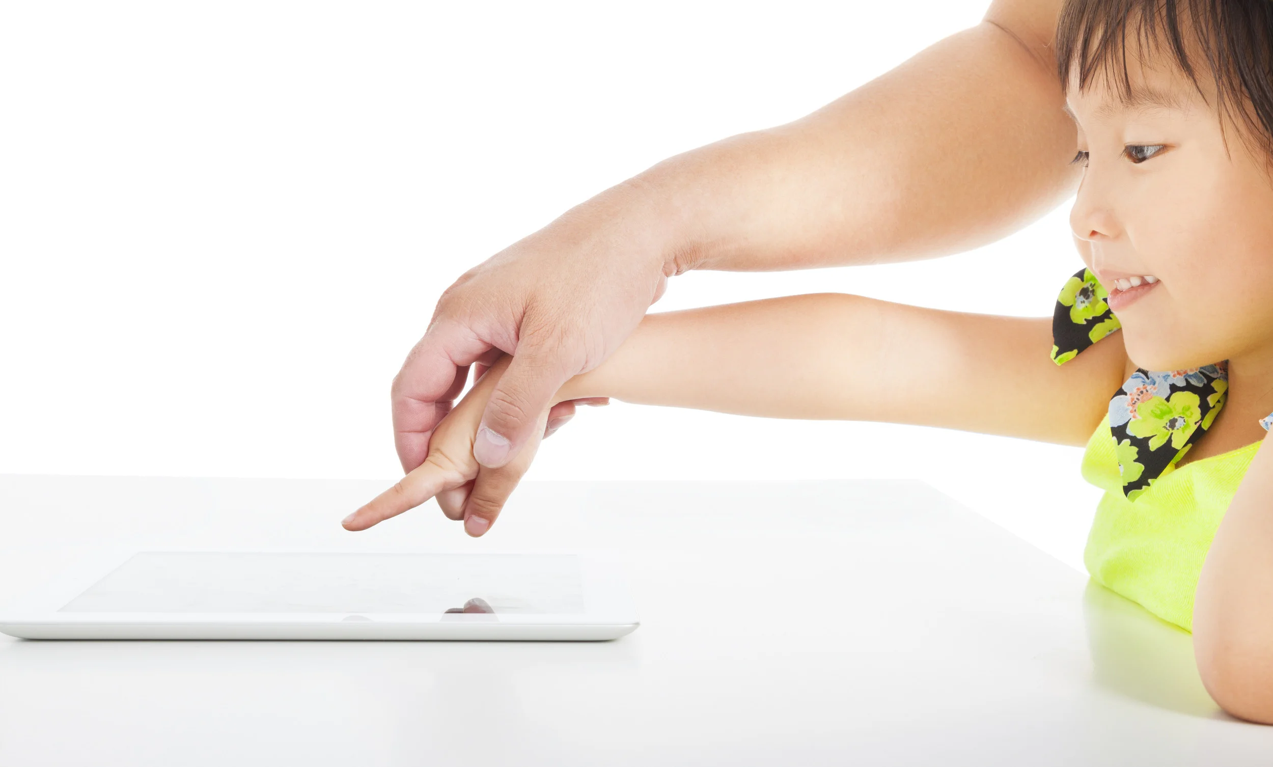 father teaching little girl's touching the tablet pc by hand