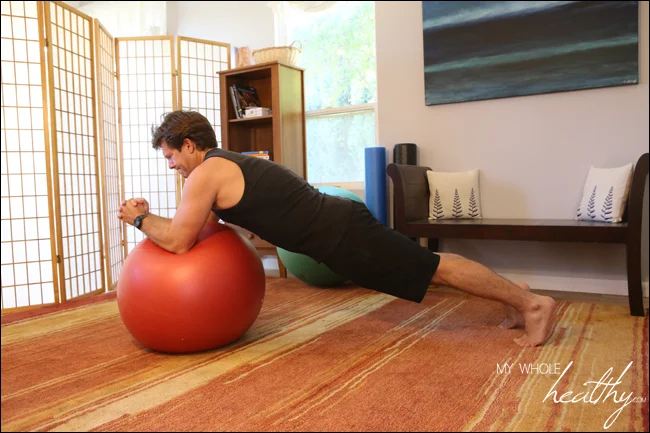 As you can see, my husband is very strong and this was challenging even for him. Beyond the abdominal work of holding the plank position and extending the arms, the ball introduces instability that must be overcome as well. I would not attempt this alone unless you are certain you can do it safely.