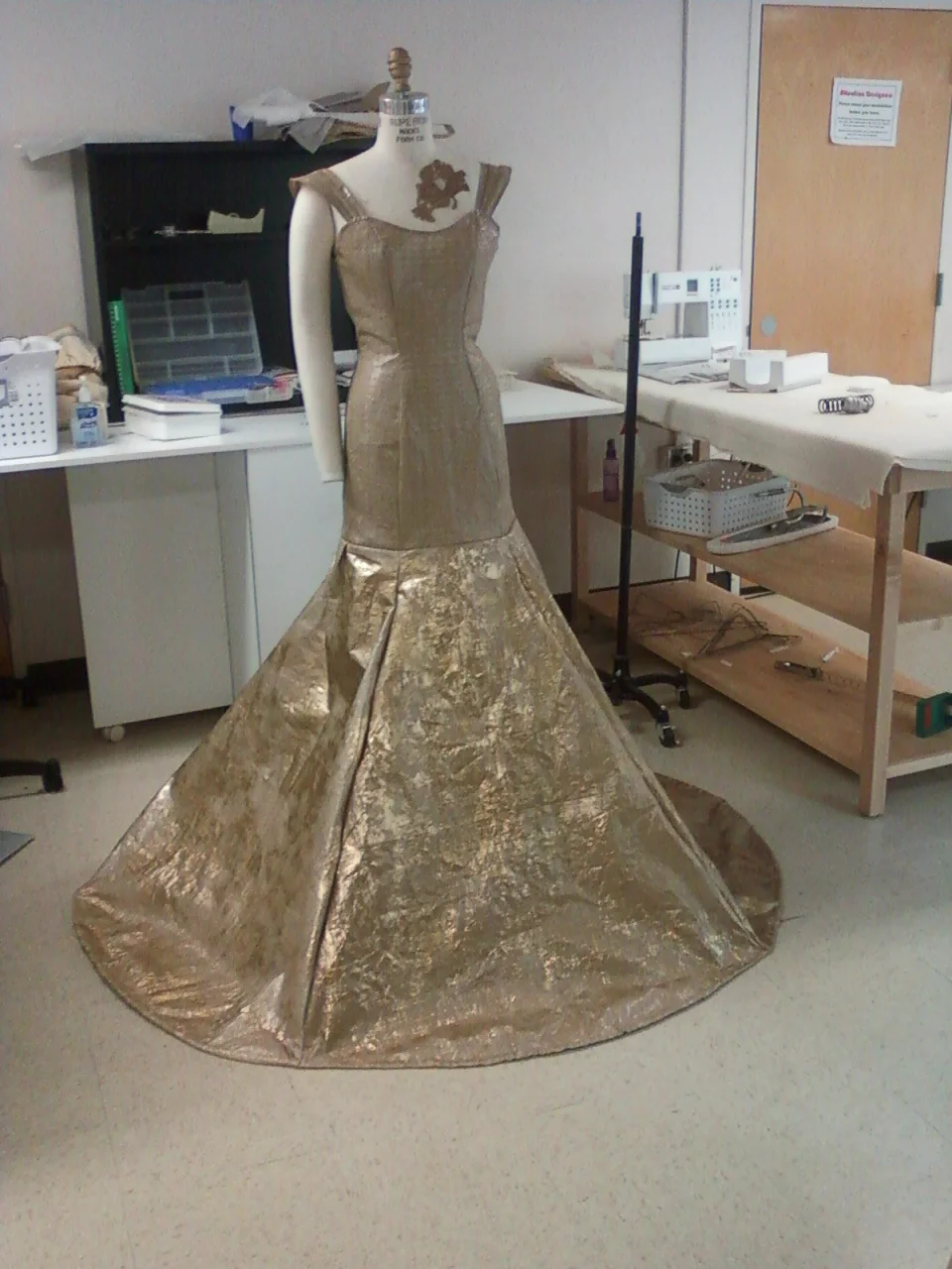  This is a recycled garment made for a sustainability project. It's made with apparel/bulk textile shipping bags that are essentially plastic burlap. 