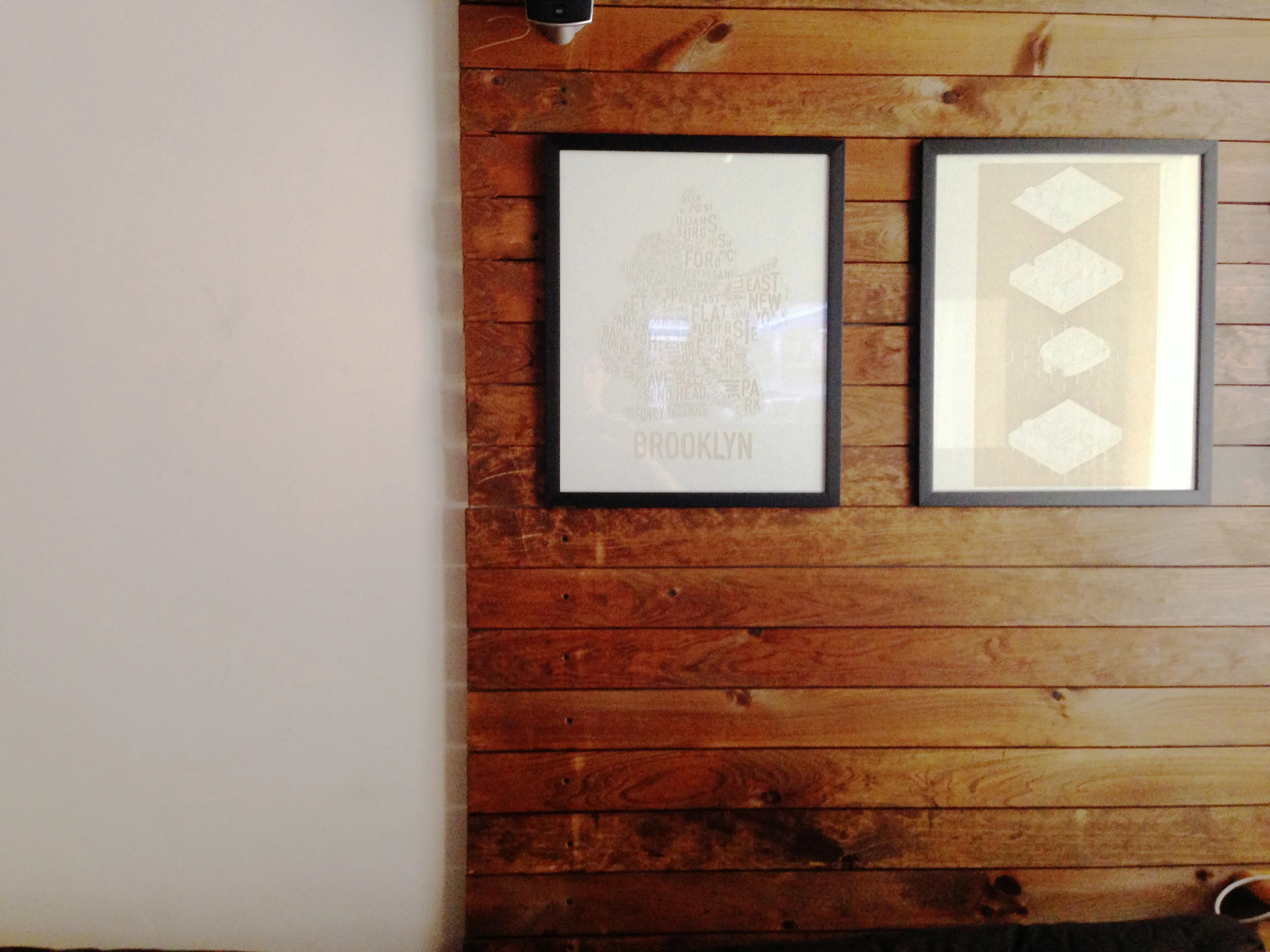 The wood helps to distinguish the living room from the kitchen and also becomes a functional way to hide wires and cables.