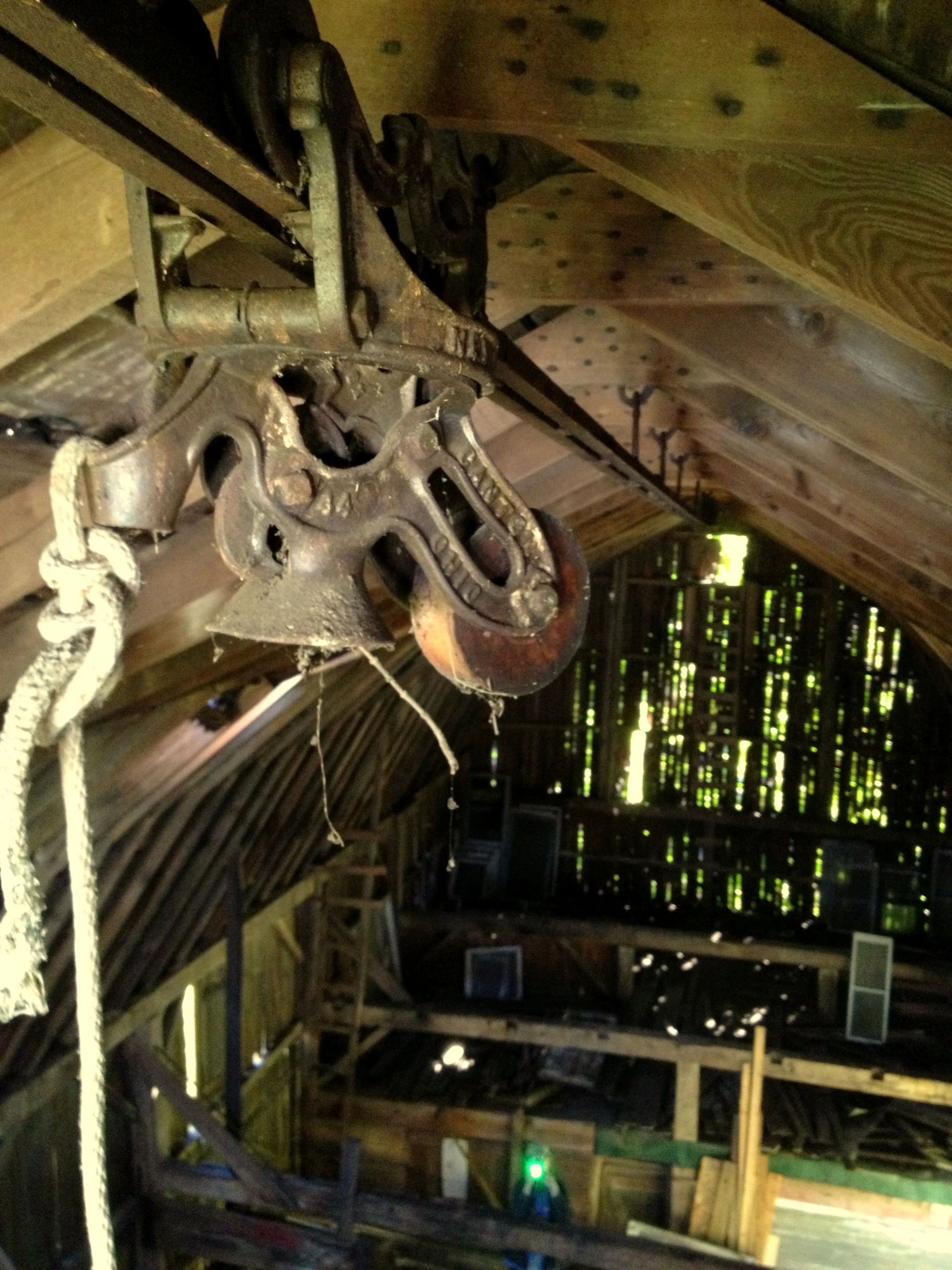A hay trolley on its tracks in the loft of a barn