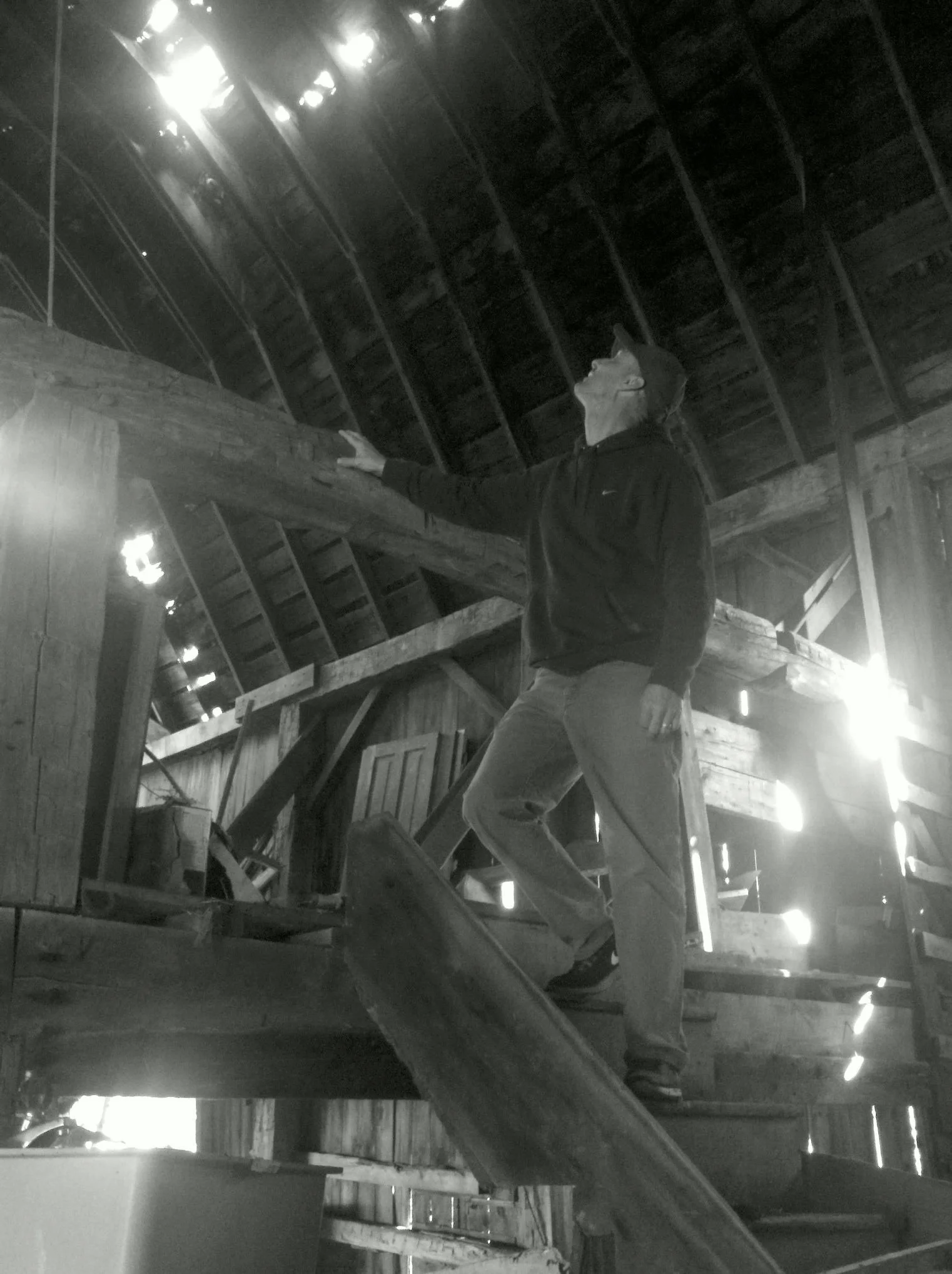 Myself, gazing at a hay trolley in an old barn