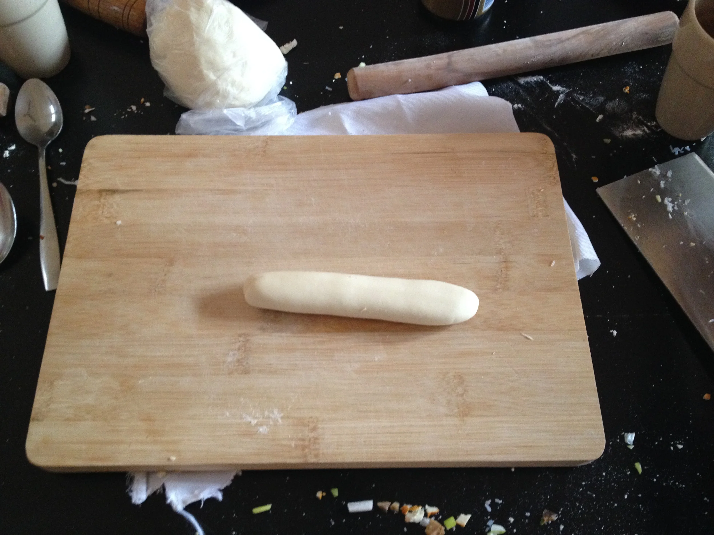 Log of dough waiting to become dumpling wrappers.