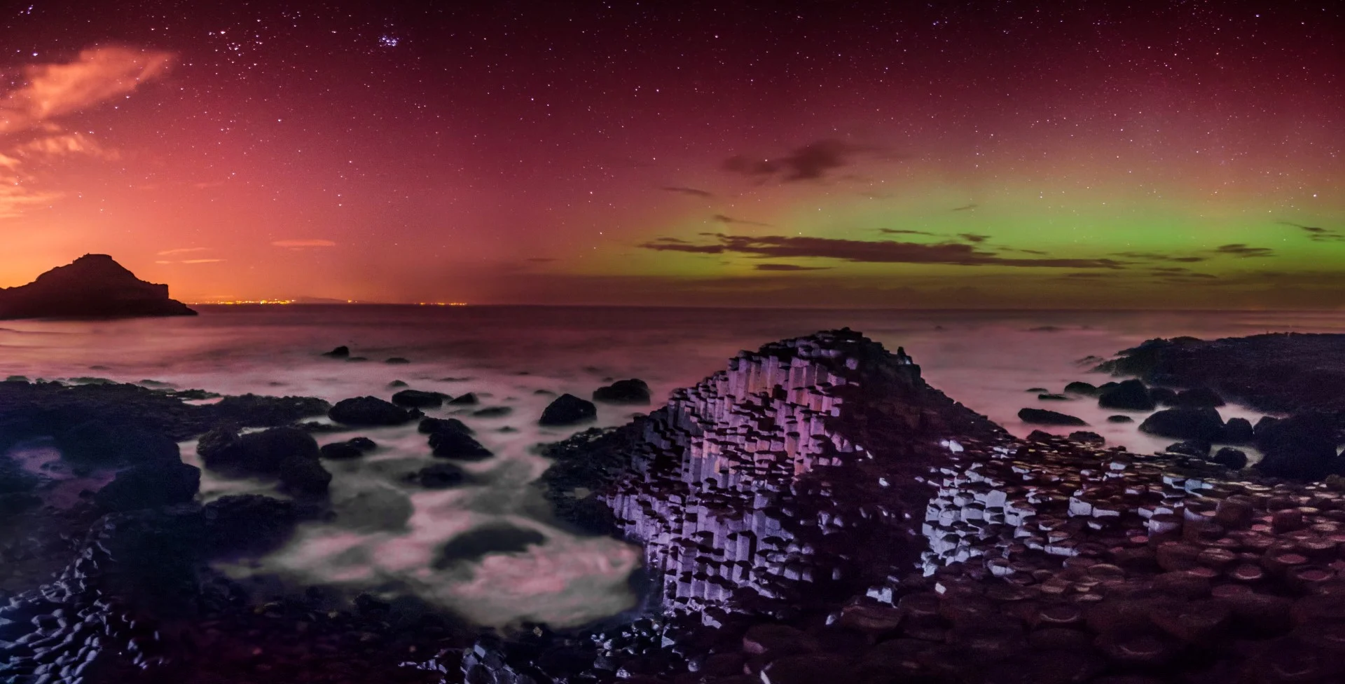 A four vertical-shot stitched panoramic of the aurora at the Giant's Causeway.