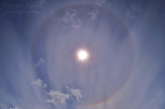 A 22 degree halo during the day . This was the first time I photographed this phenomenon. You can clearly see the rainbow like colours in parts of the ring.
