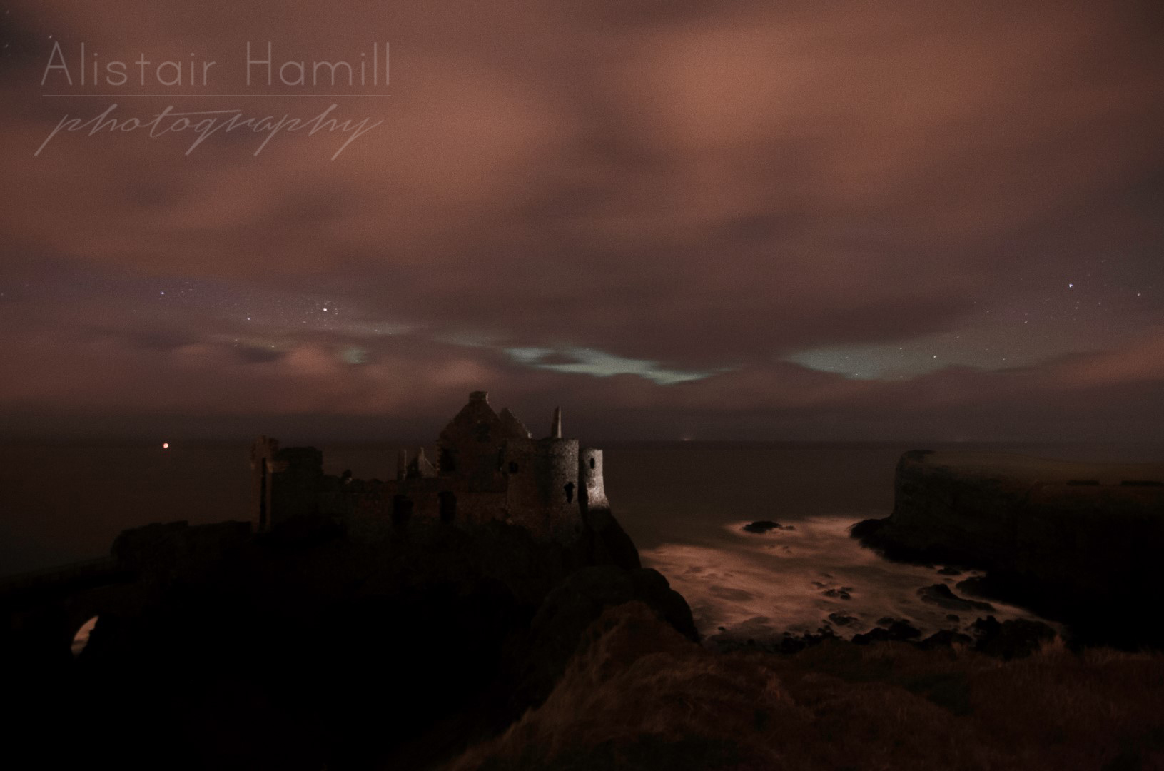 The scene closer to what it looks like with the naked eye. The lighter portions running horizontally are not lighter cloud in front of the cloud banks, but breaks in the cloud with the tell tale whitish glow of an aurora being revealed behind.