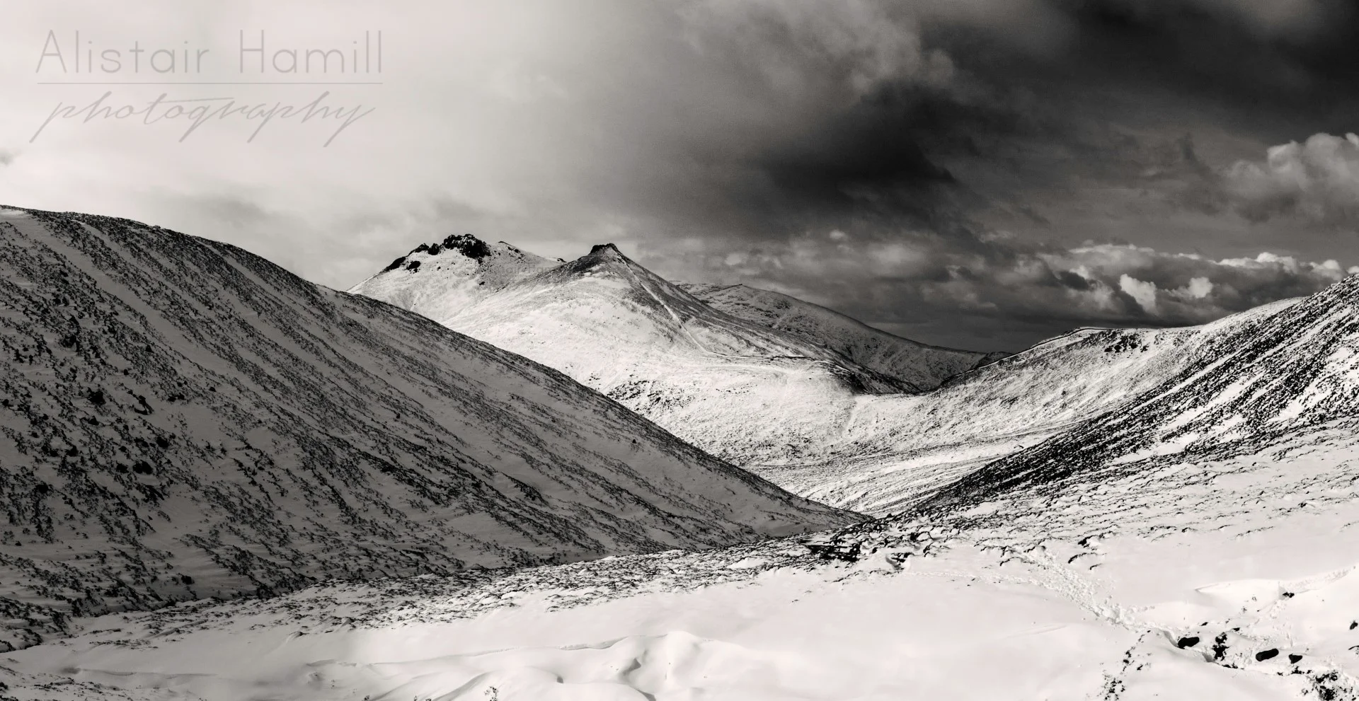 The twin tors of Bearnagh loom large in the distance in this view from the Brandy Pad