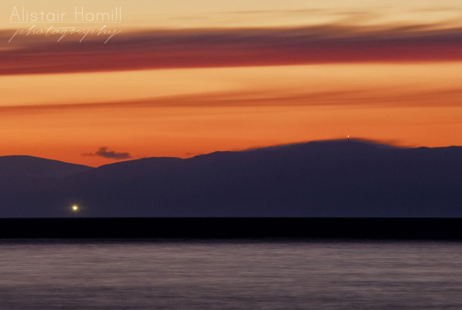 The lighthouse on Mull of Kintyre - along with a light on top of a hill top mast to the right just poking above some orographic cloud that is draped over the summit - have a close look to see if you can spot it!