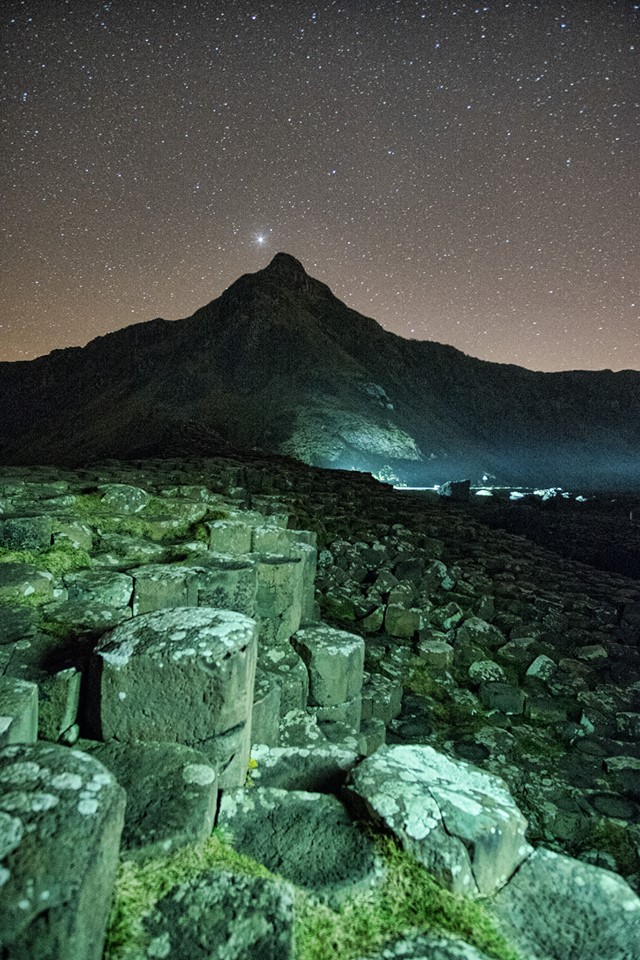 Image taken by one of the workshop participants, Patsy Ma Reavy, while I painted the stones with some light for her. And there's Jupiter just above the headland!