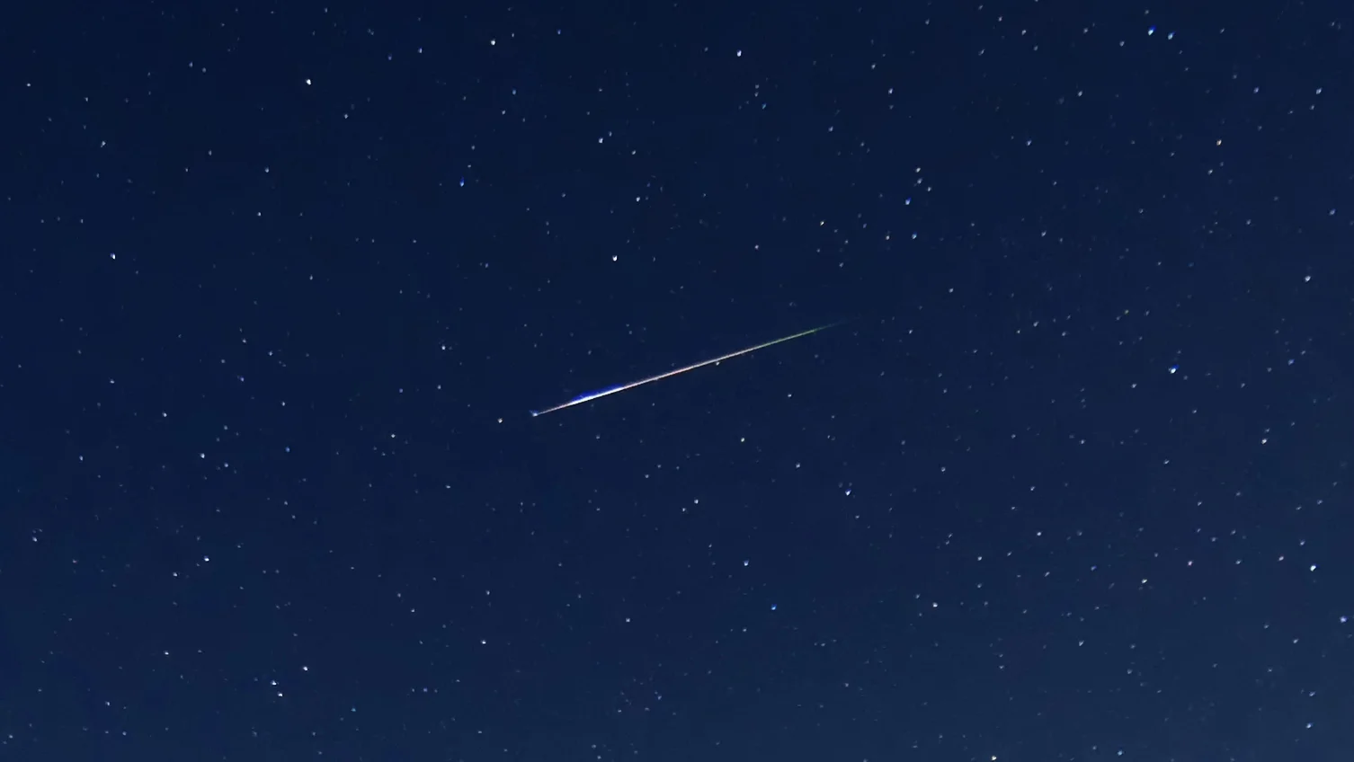 Close up of the main meteor I was able to capture. This one streaked across the sky, leaving behind a trail that fizzled in the atmospherte for a few seconds. Note the green tinge on the end of the meteor trail.