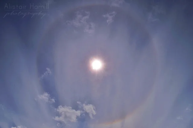 Day time 22 ° halo around the Sun - note the rainbow colours.