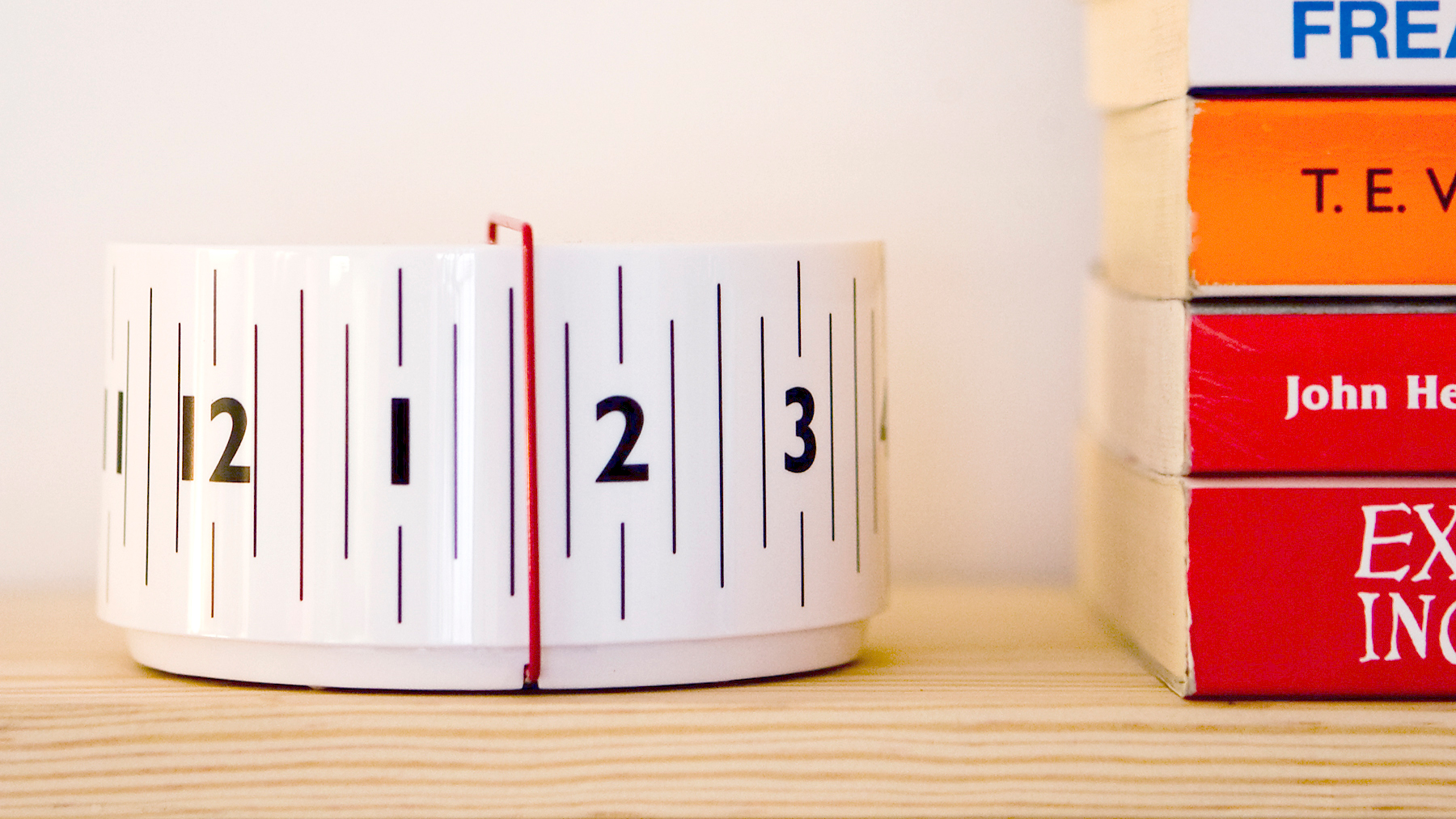 The 'Around Clock’ came about through a desire to represent time in a more natural and realistic way than a traditional clock. Our sense of time passing is marked by the earth rotating into and out of sunlight and a linear solution best reflects this process. The cylindrical body of the Around Clock rotates behind the static red time line so we simultaneously see the past slipping away, the present and the ever-approaching future. Image © Hugh Dickens