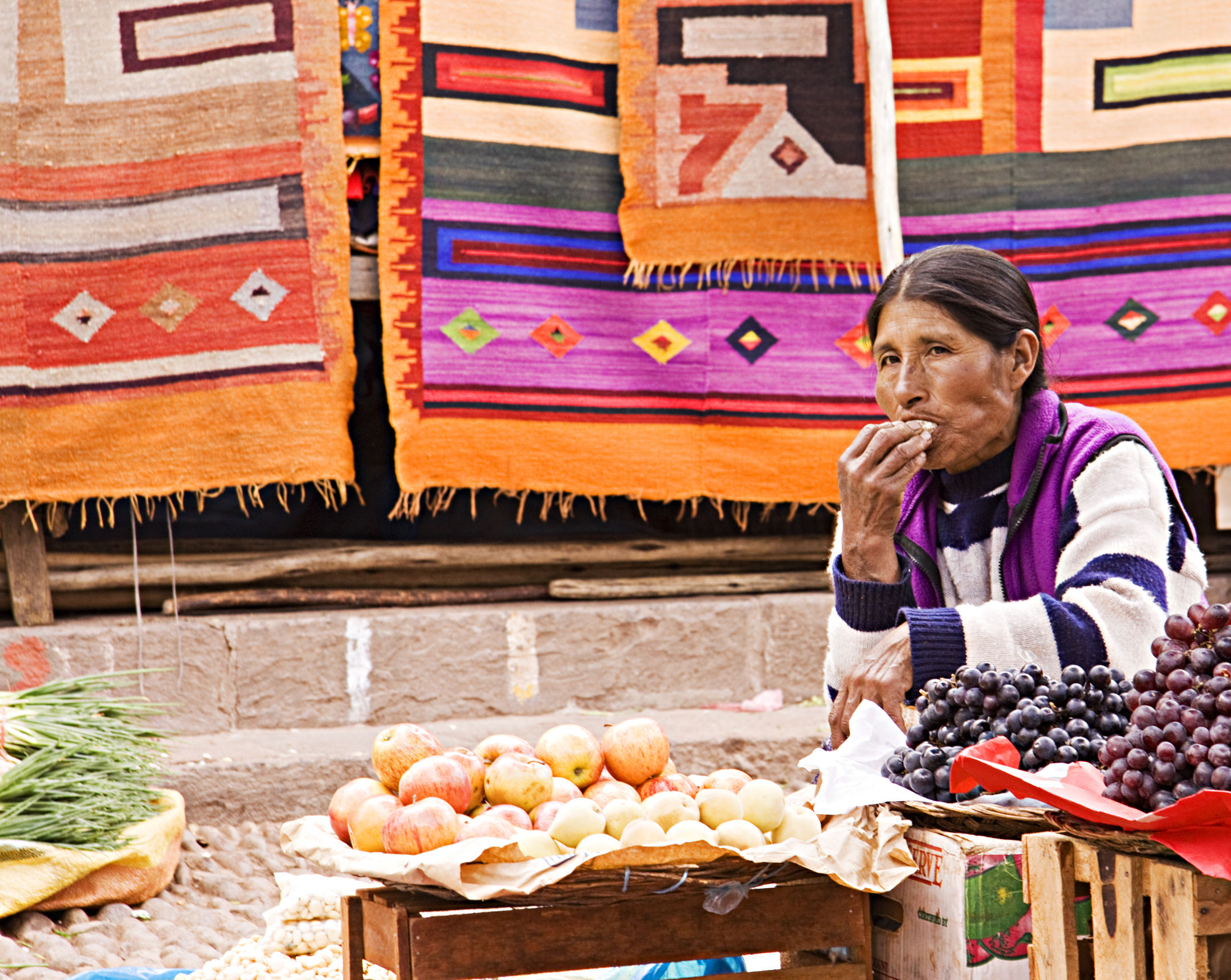 This woman will not start her bargaining until she finishes her snack.