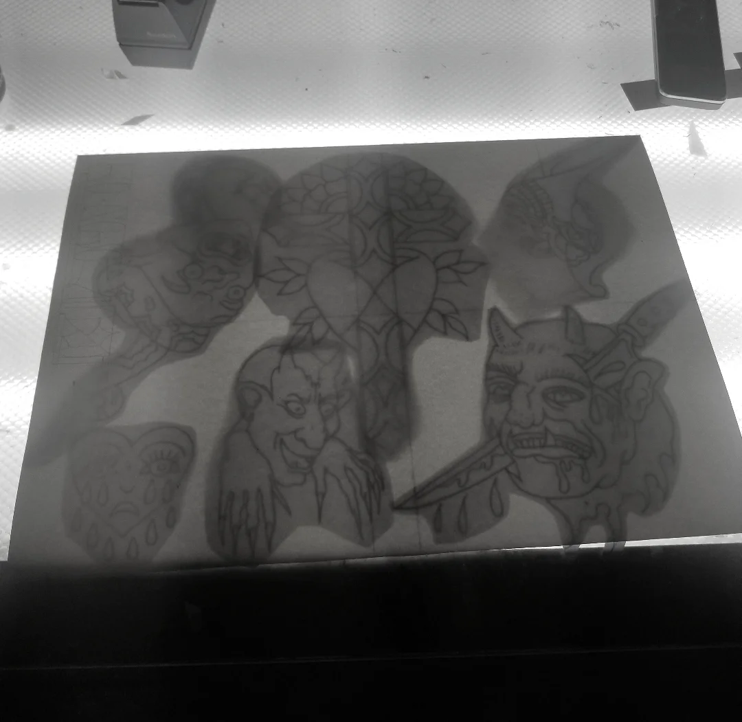 Prior I drew up each individual piece of flash on regular copy paper and roughly resized them each with the copy machine as needed. Then I taped each design into place to make a composition that looked good to me on the back of the watercolor paper. Using the light box I can clearly see all the designs through the thick watercolor paper. 