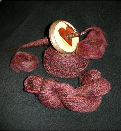 Clockwise, from left: Ashland Bay Colonial Top, Kundert spindle resting on singles of unknown WPI, my first finished 2-ply.