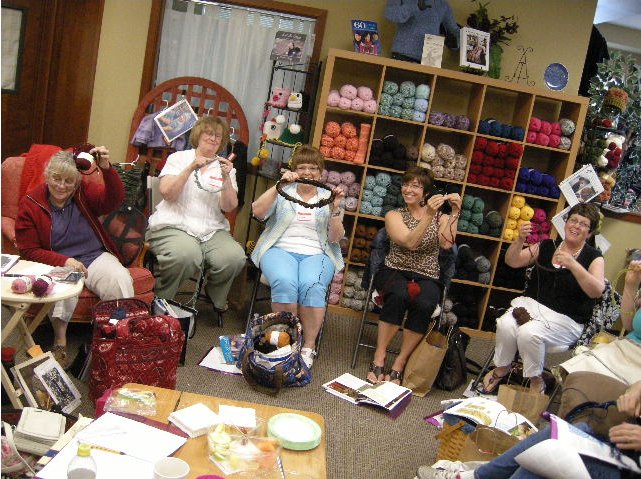 My proud and fiesty knitters hold up their completed cast-ons, while I cheer for them.