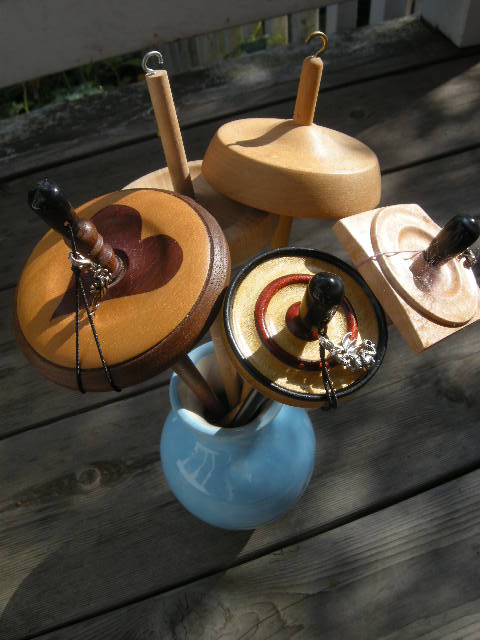 High-whorl drop spindles, clockwise from top: Ashford , Spindlewood , Spindlewood , Kundert , homemade.