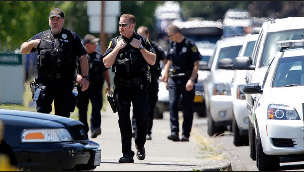Police in flak vests in the school parking lot