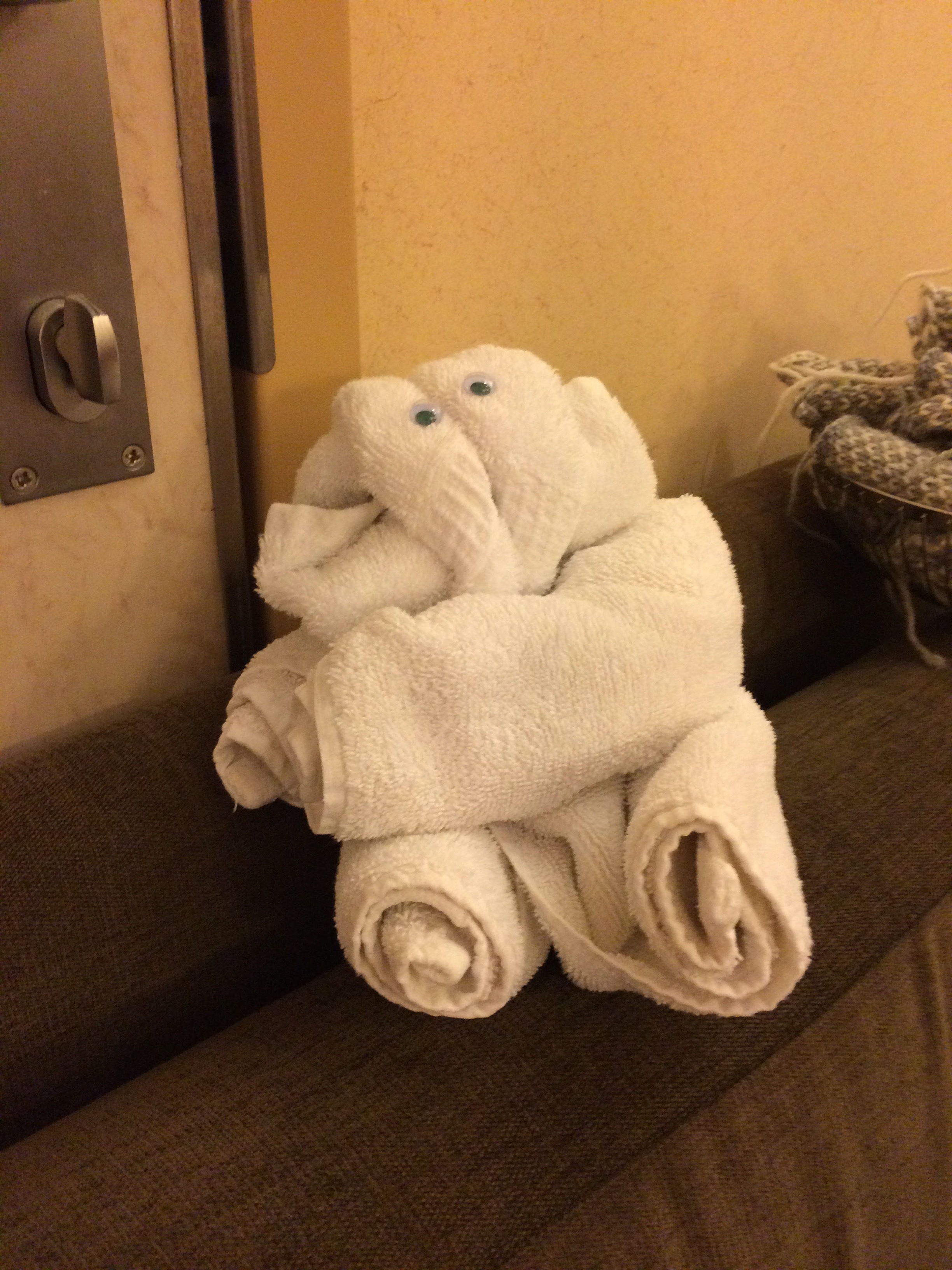 A towel elephant, by Rozy keeps a pile of steeking swatches company.