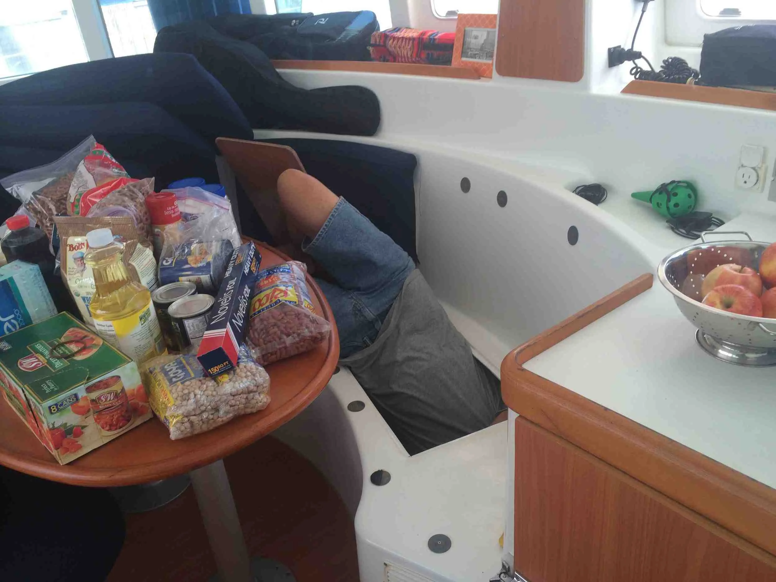 Alain - one of the technicians - working on our boat...after we'd stowed the groceries. He looks how I feel.