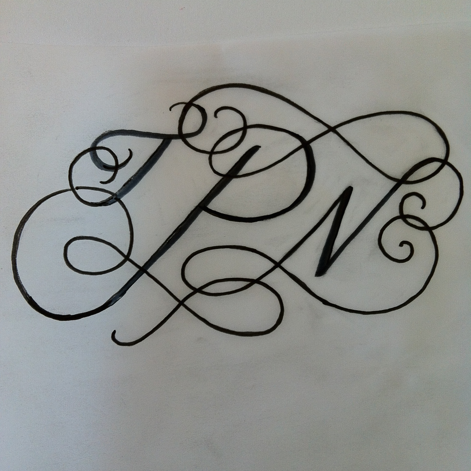 Original rough pen sketch of the monogram.