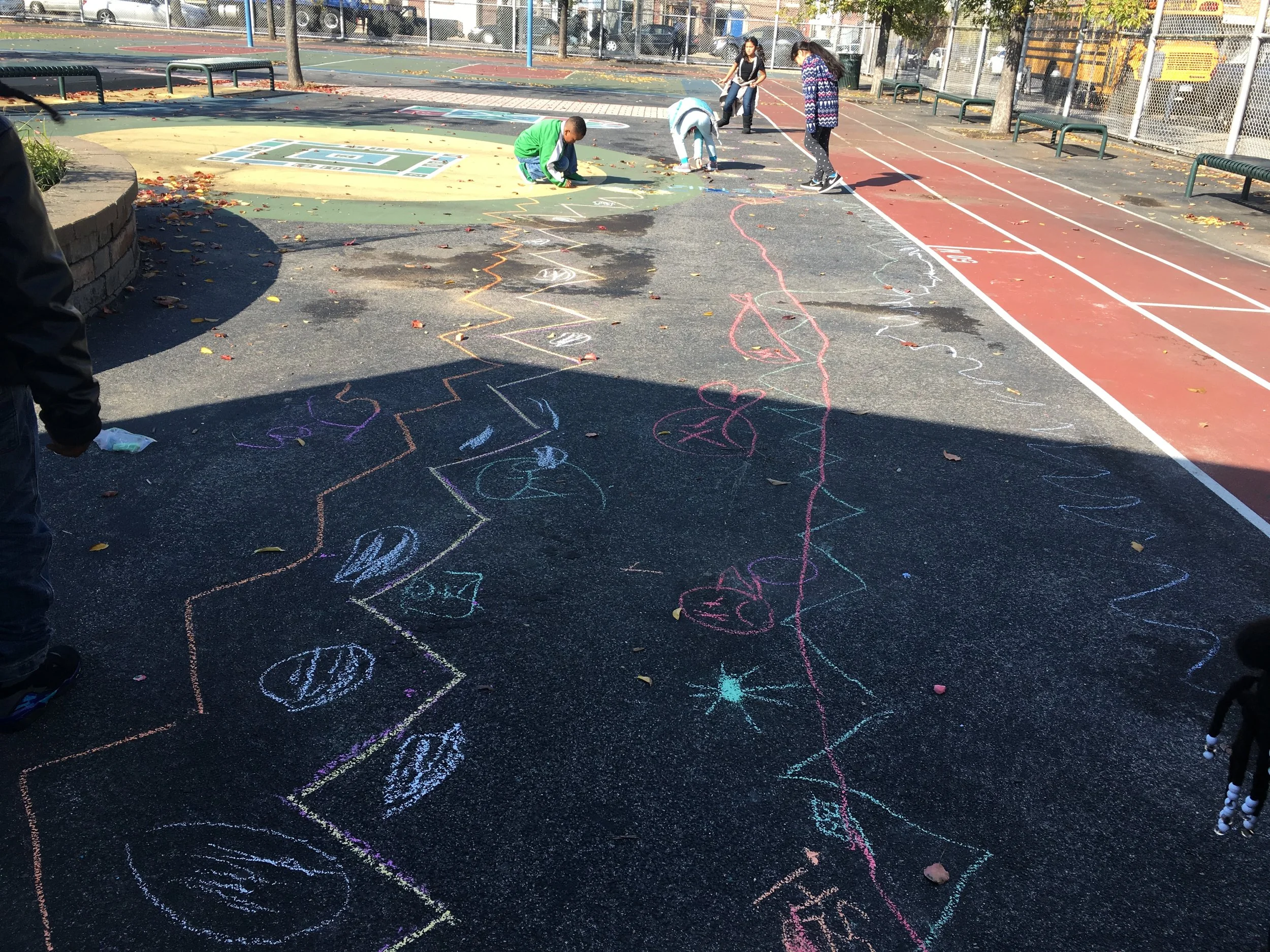 Groups of students worked together to create giant racetracks, mazes, and hopscotches and test them out.