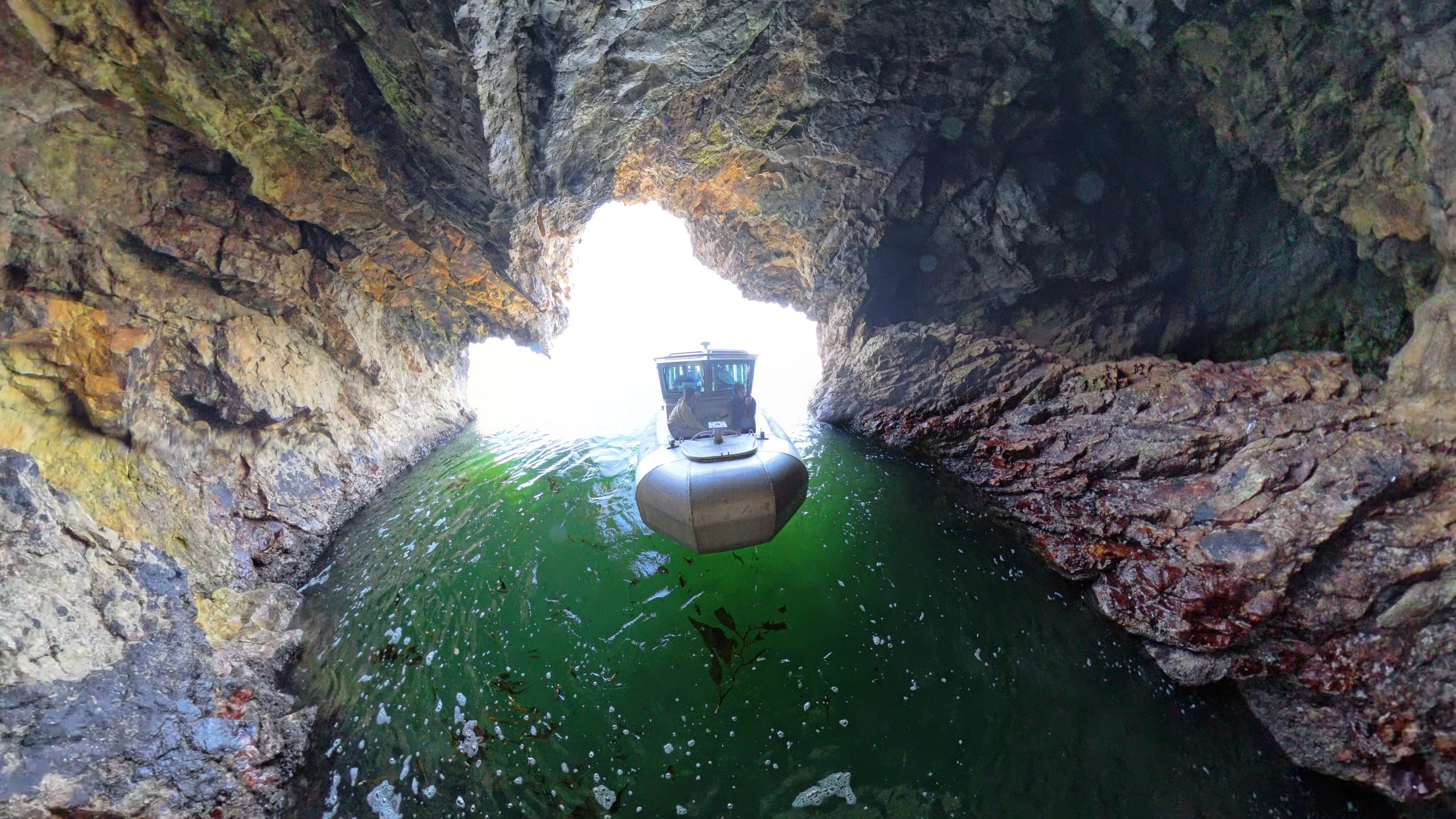 Orca tour boat exploring Avila Beach Sea Caves